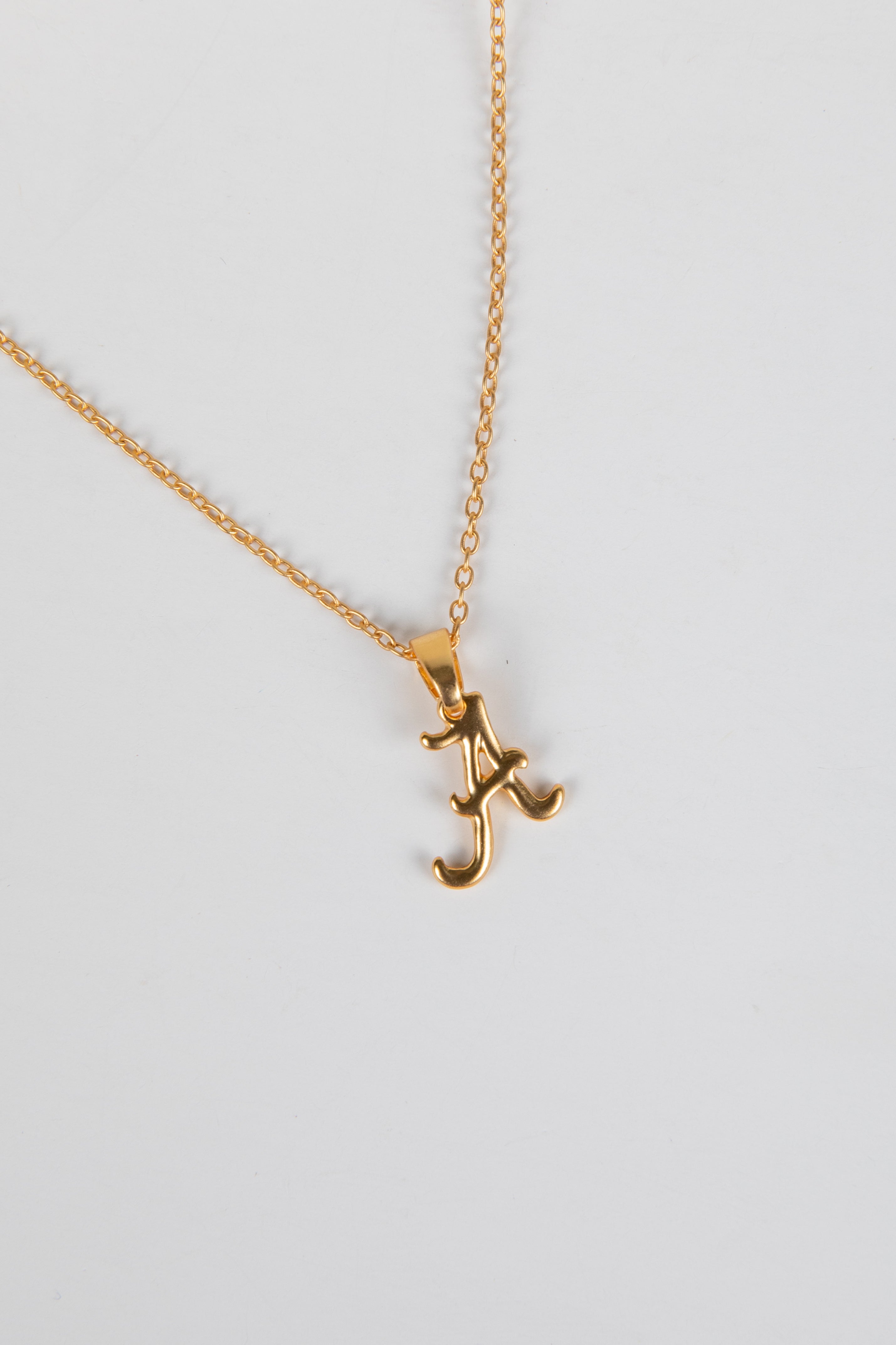 Gold necklace with a letter &
