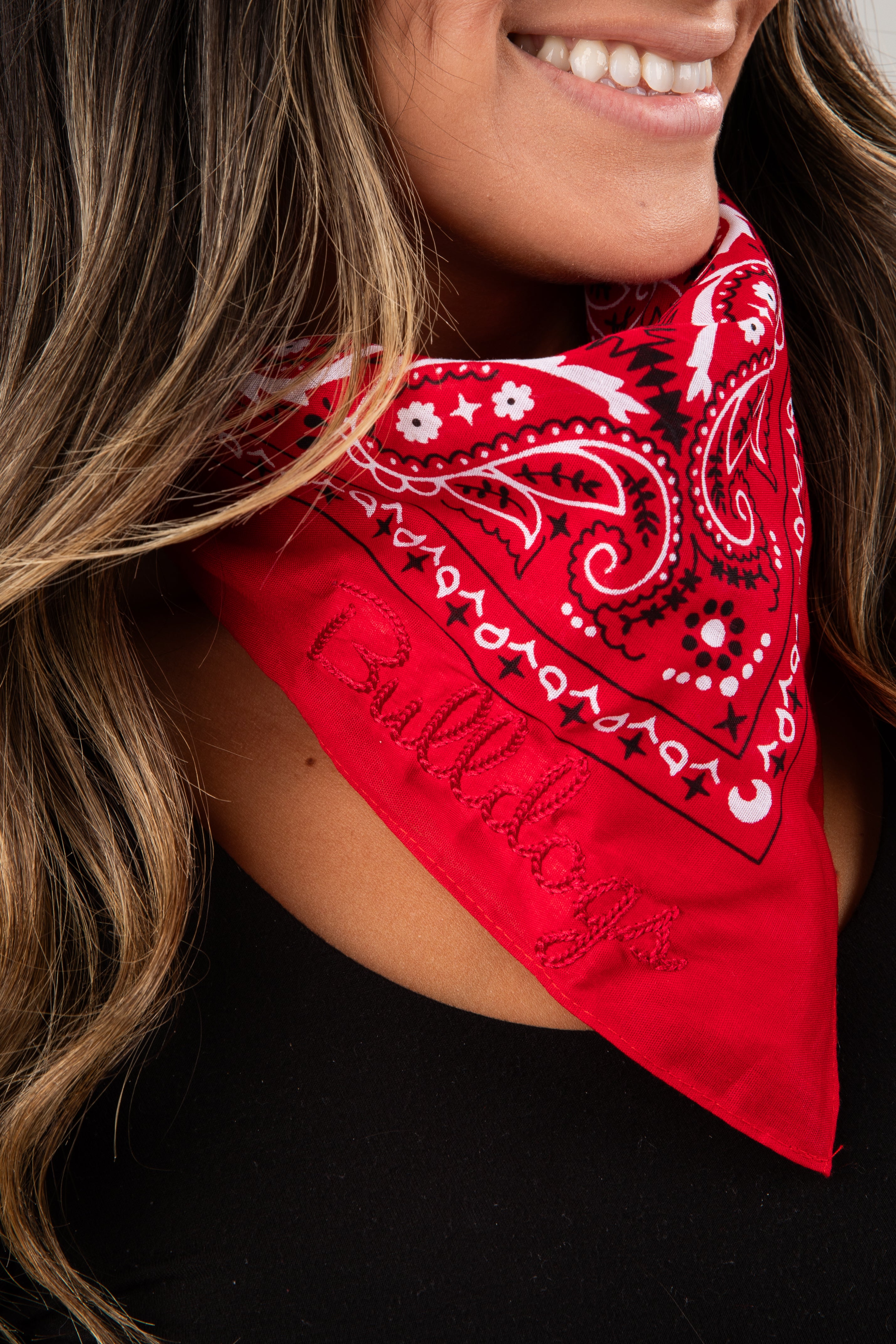 Person wearing a red bandana with black and white patterns