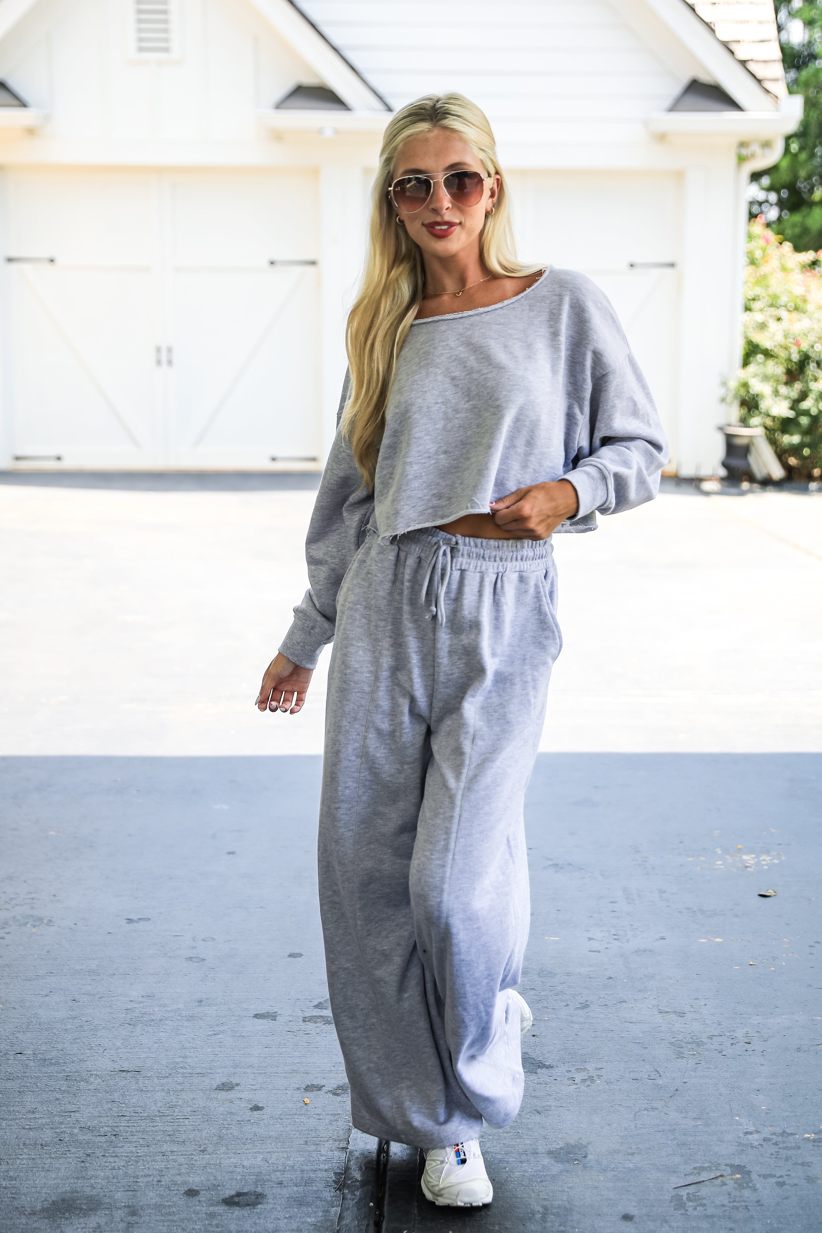 Woman wearing a gray sweatshirt and pants in an outdoor setting