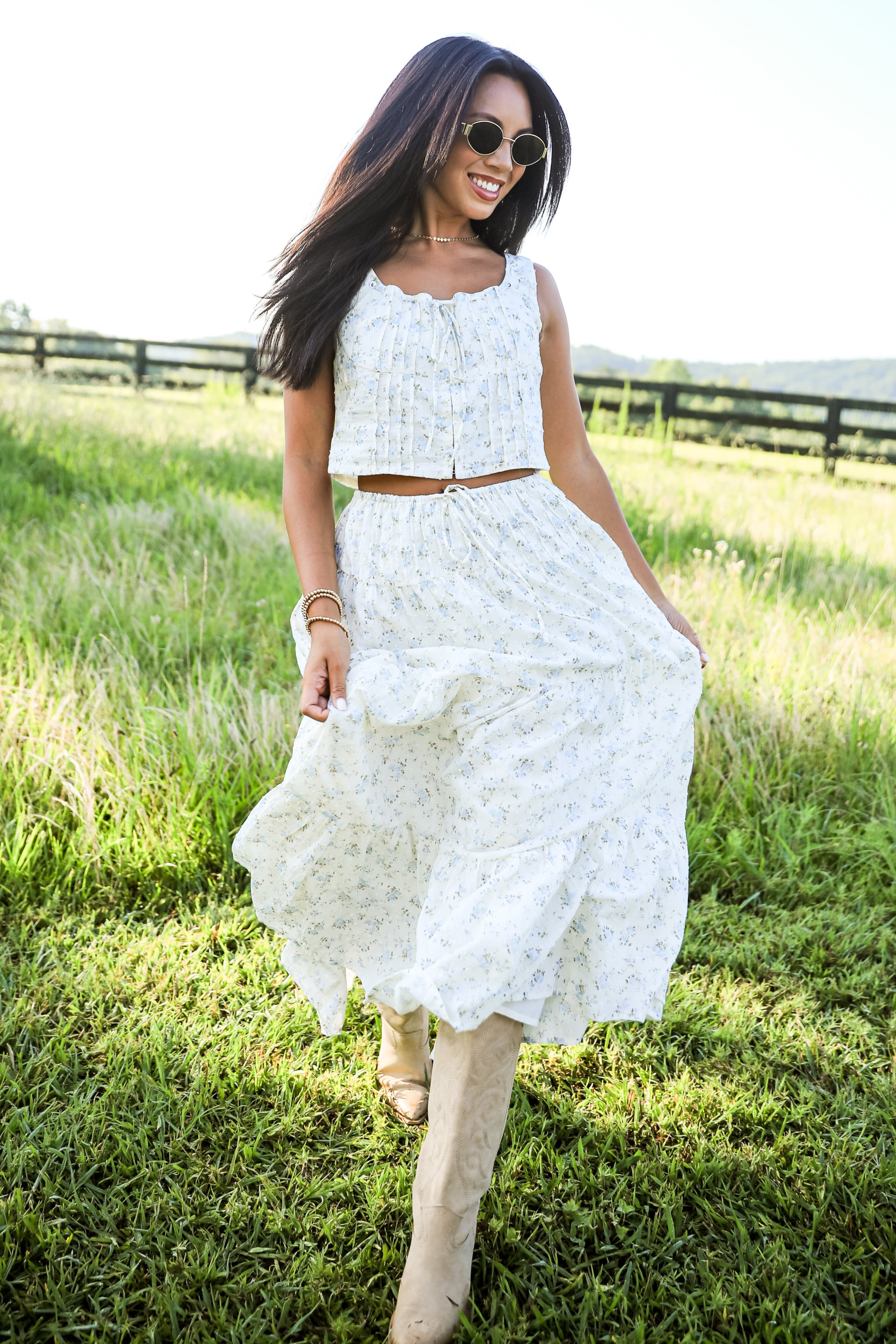 Woman in a white dress standing in a grassy field
