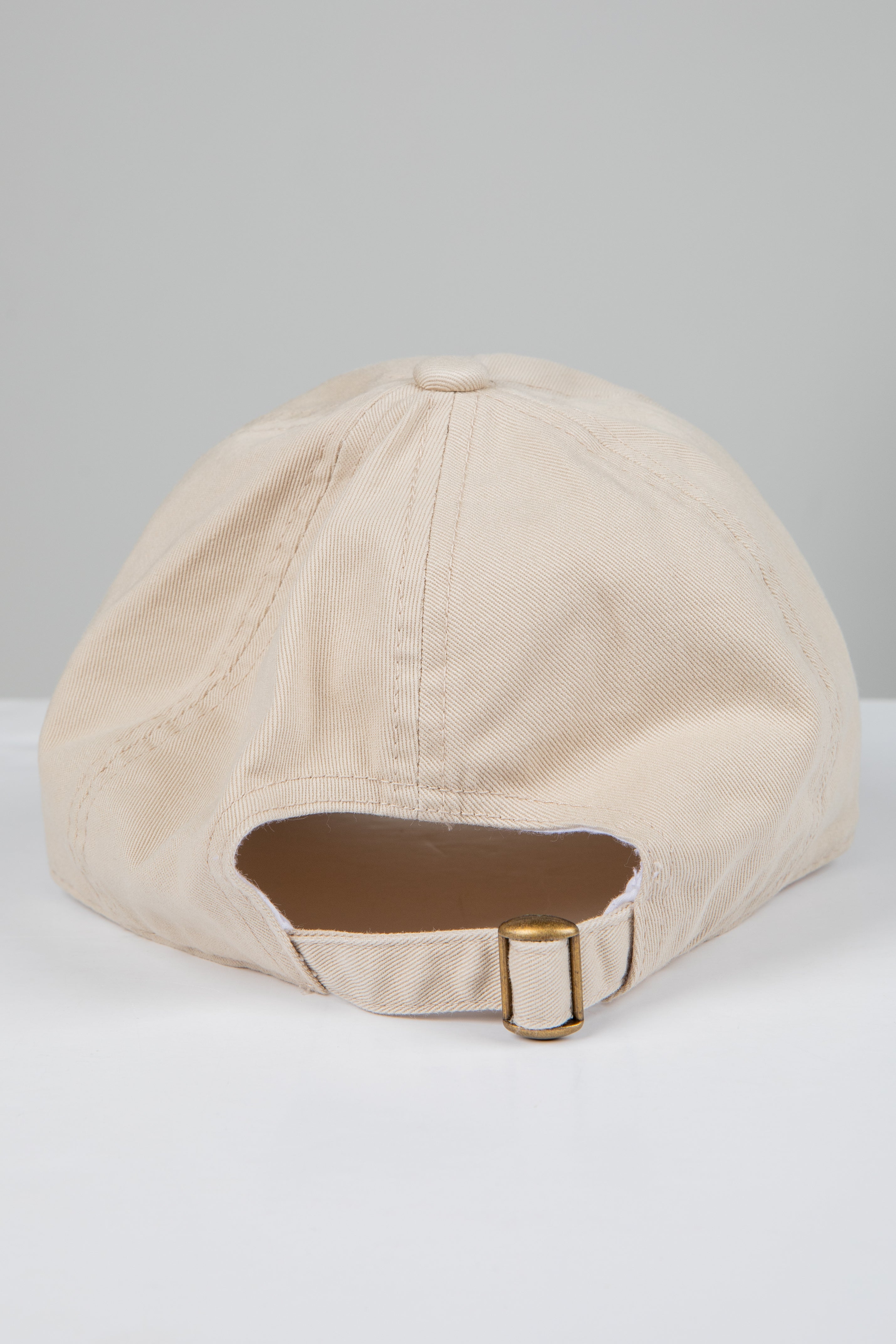 Beige baseball cap on a white background