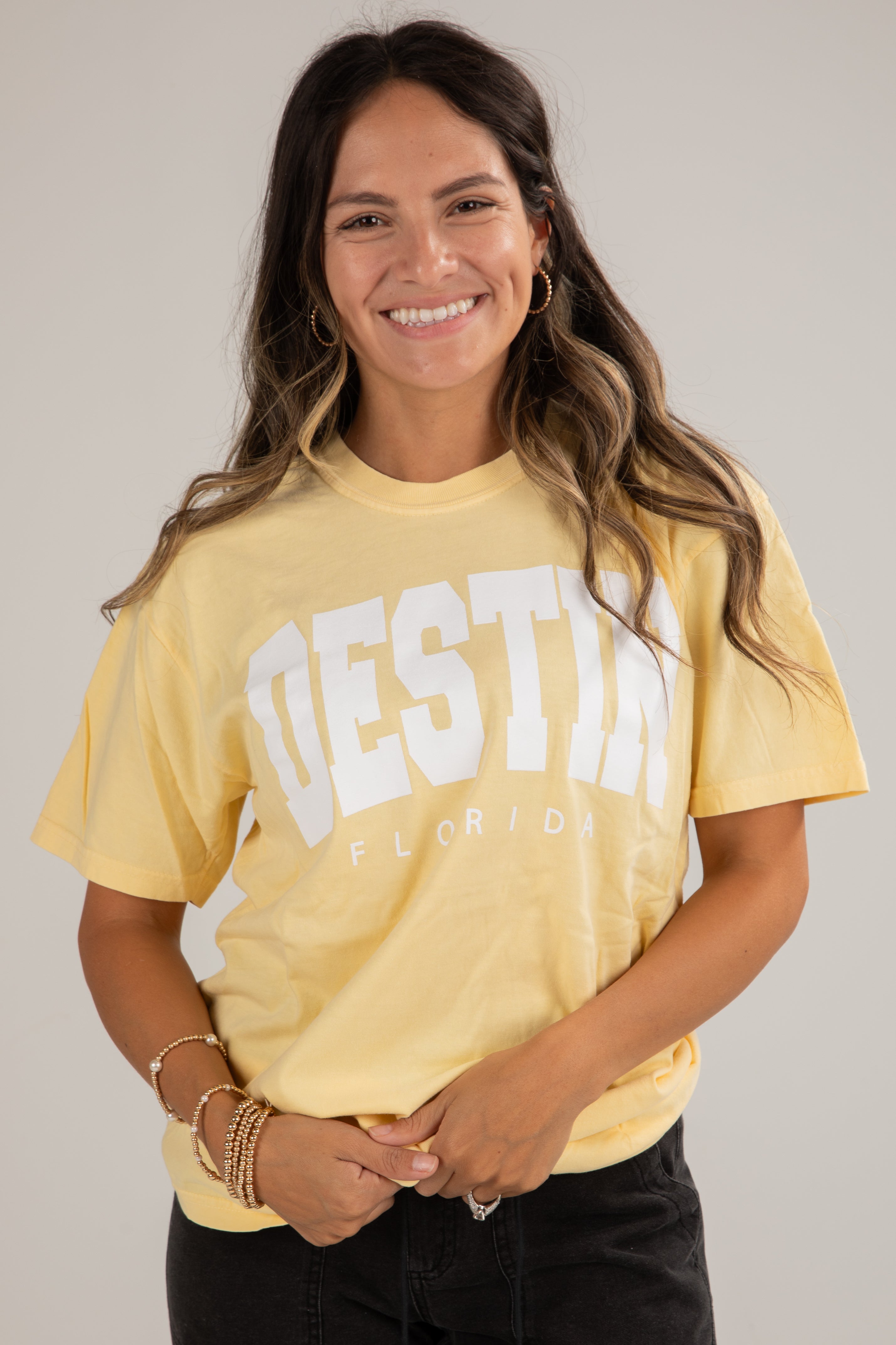 Woman wearing a yellow t-shirt with &