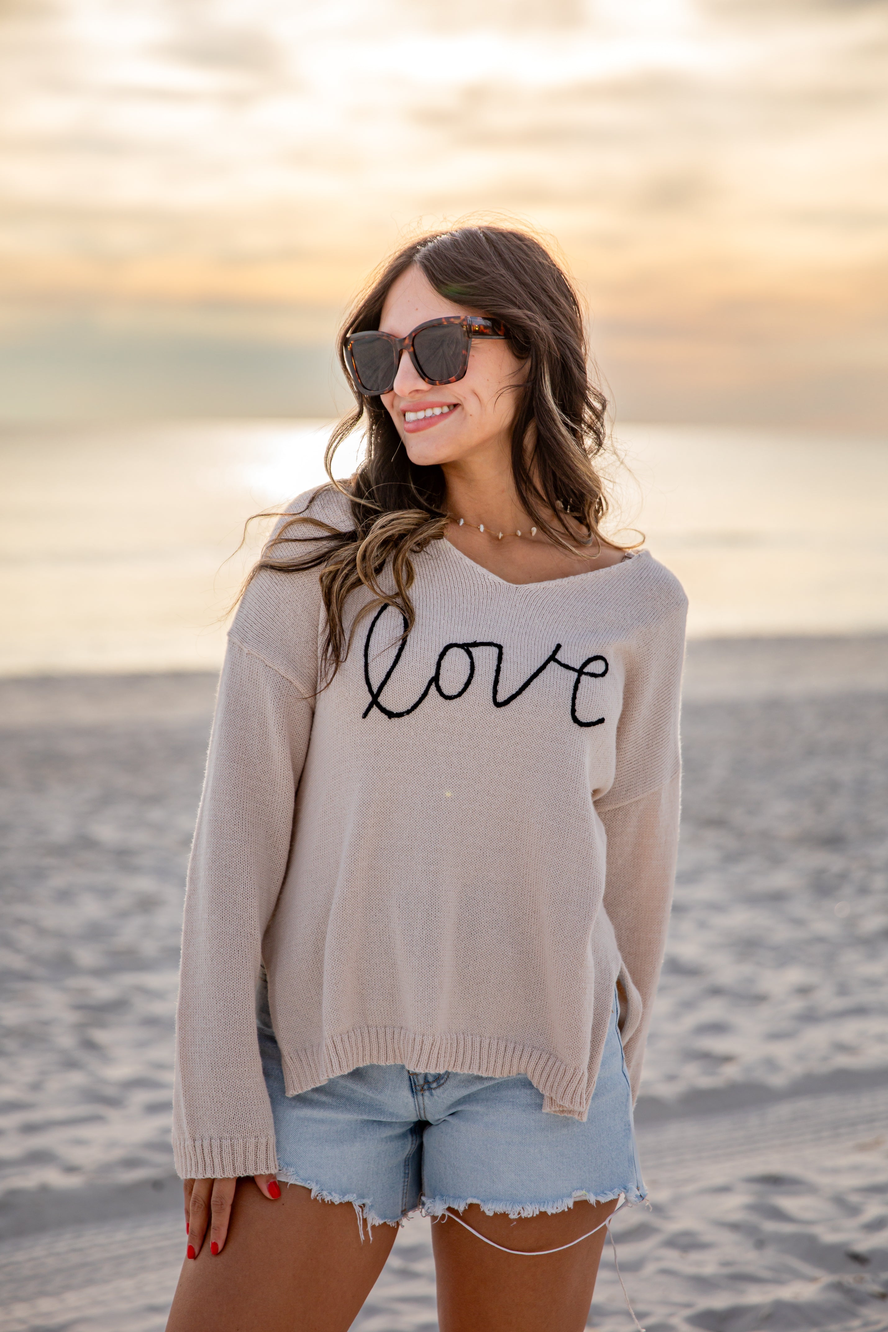 Woman wearing a sweater with &