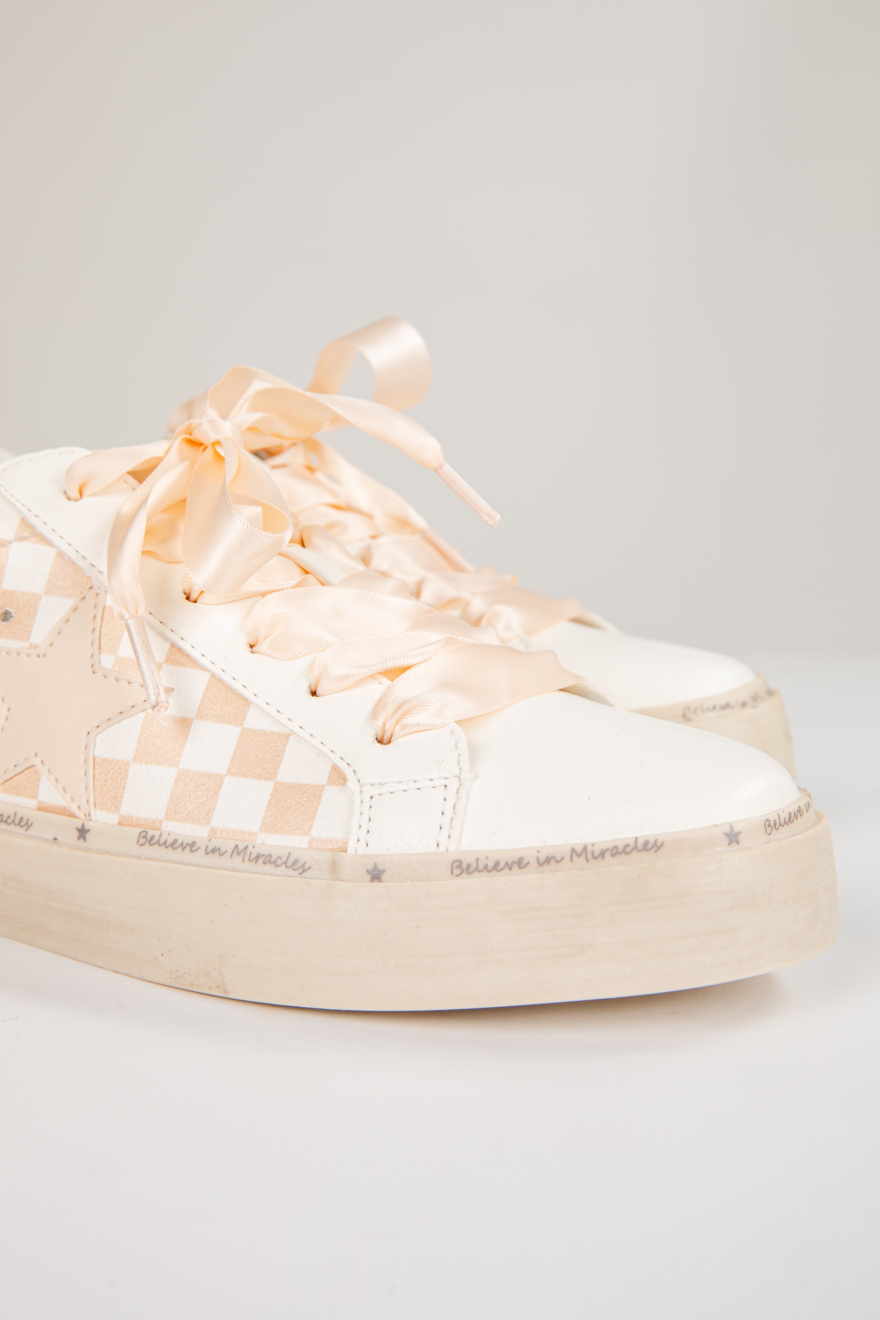 Pair of checkered sneakers on a light gray background