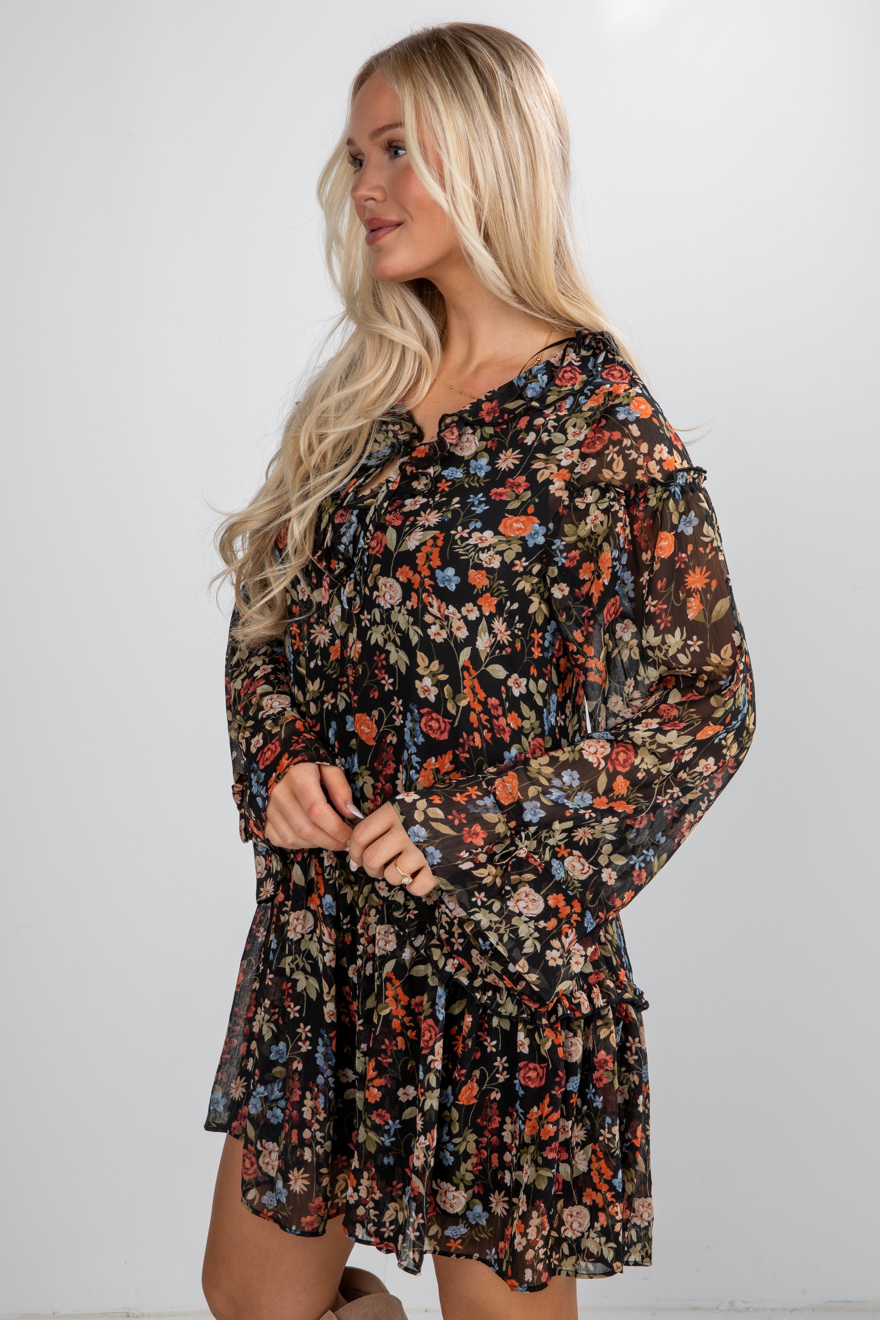 Woman wearing a floral dress against a white background