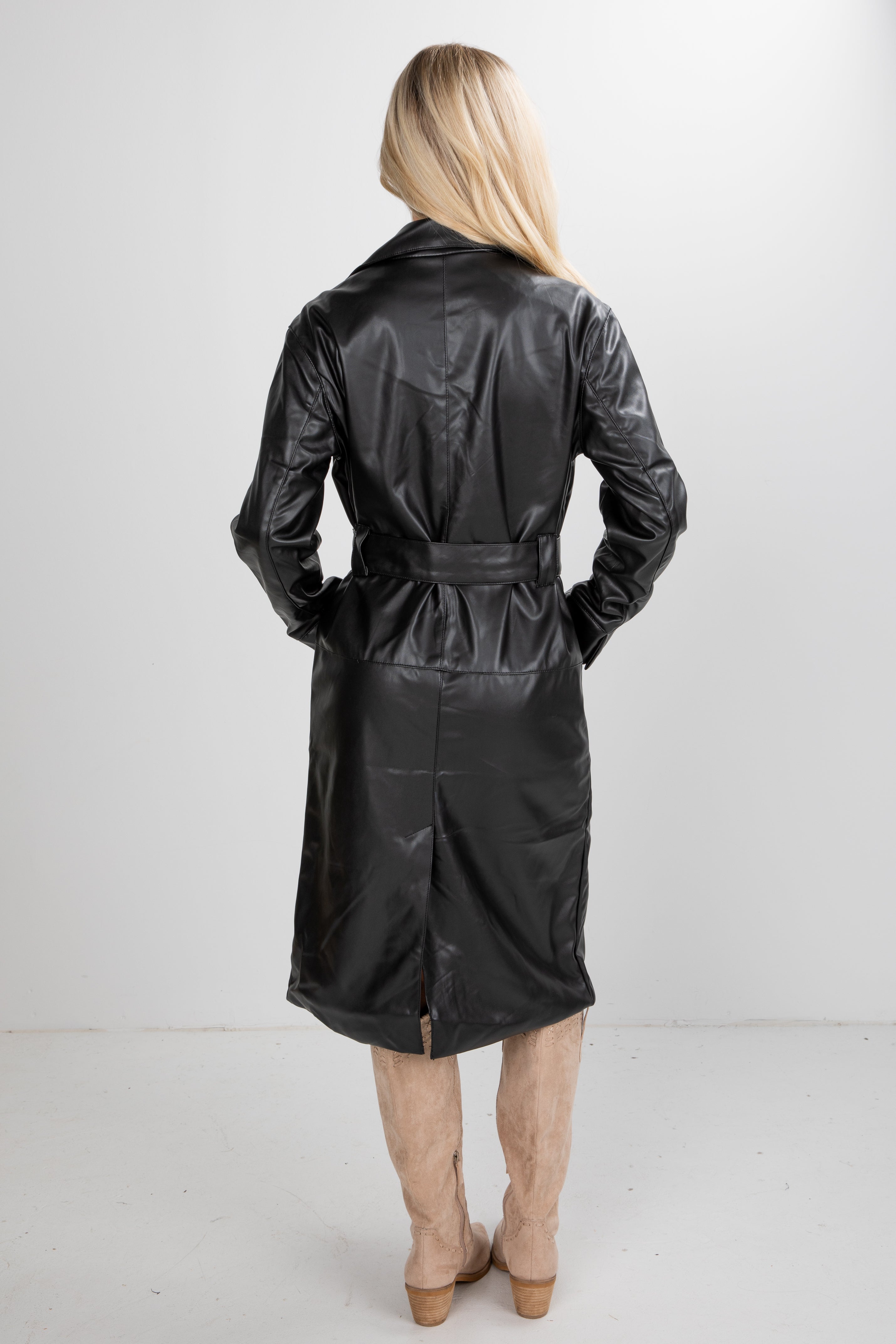 Person wearing a black raincoat on a white background
