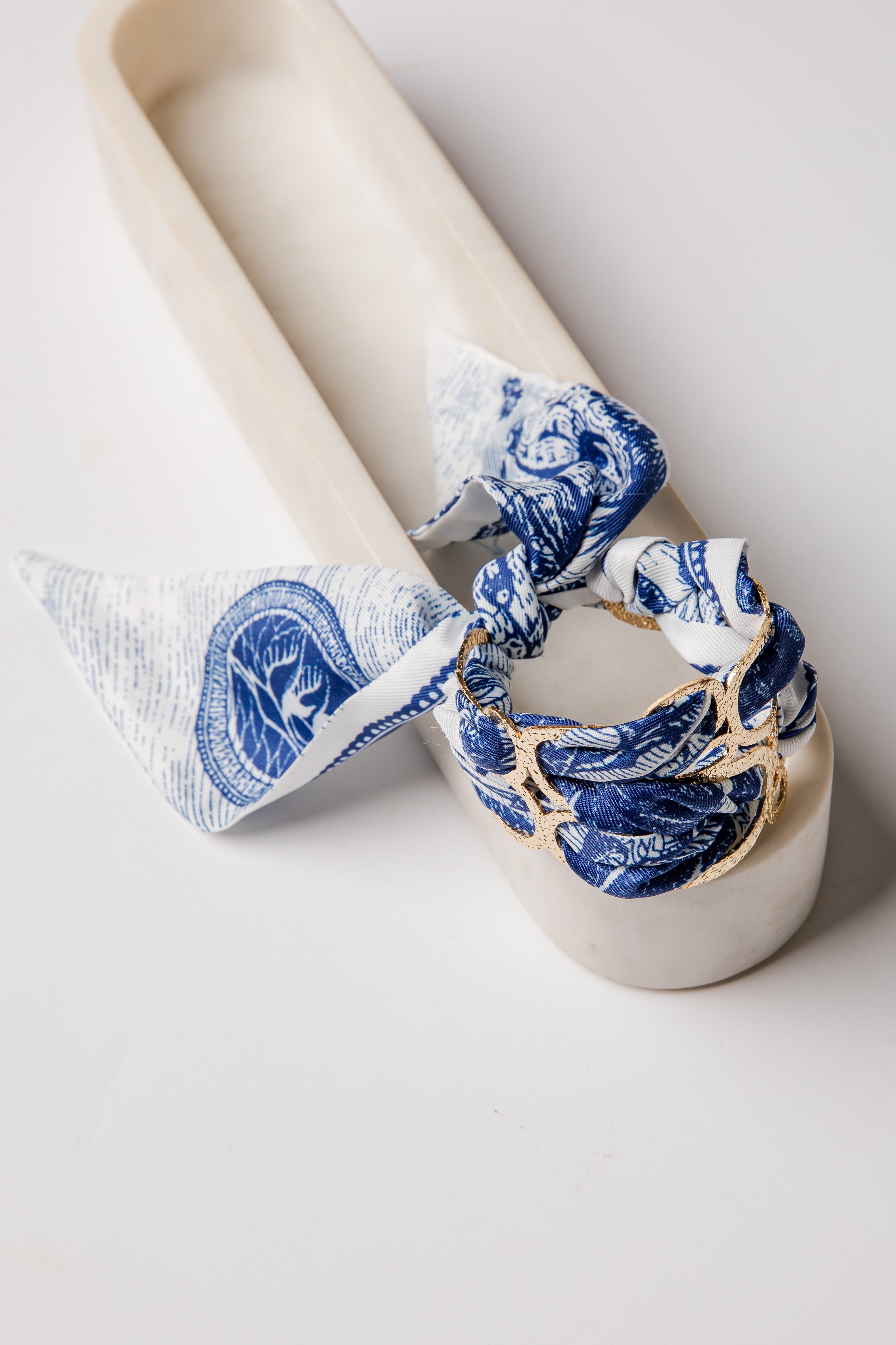 White ceramic candle holder with blue and white floral patterns on a white background
