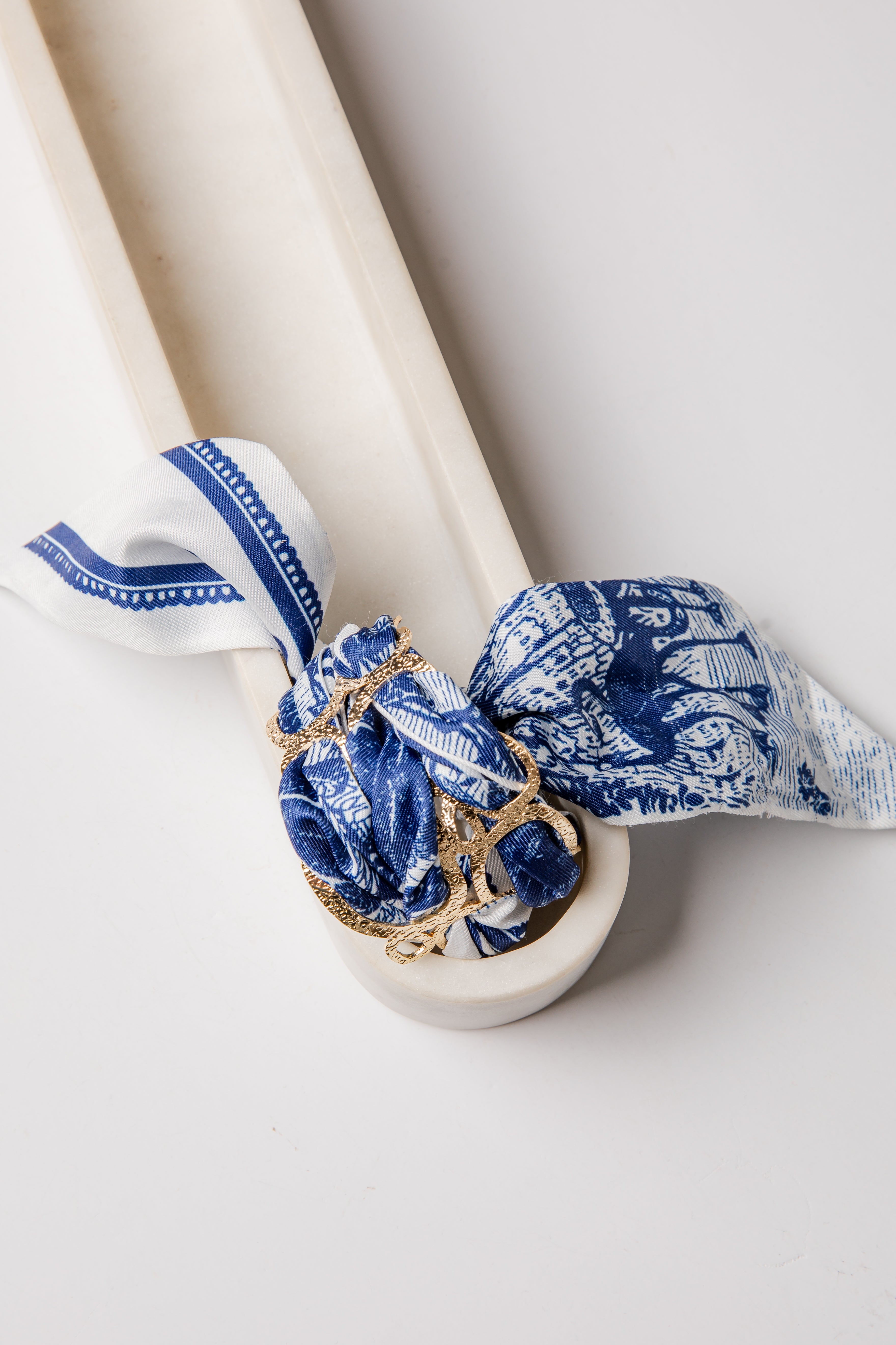White with blue decorative bracelet bandana and gold accents on a white background