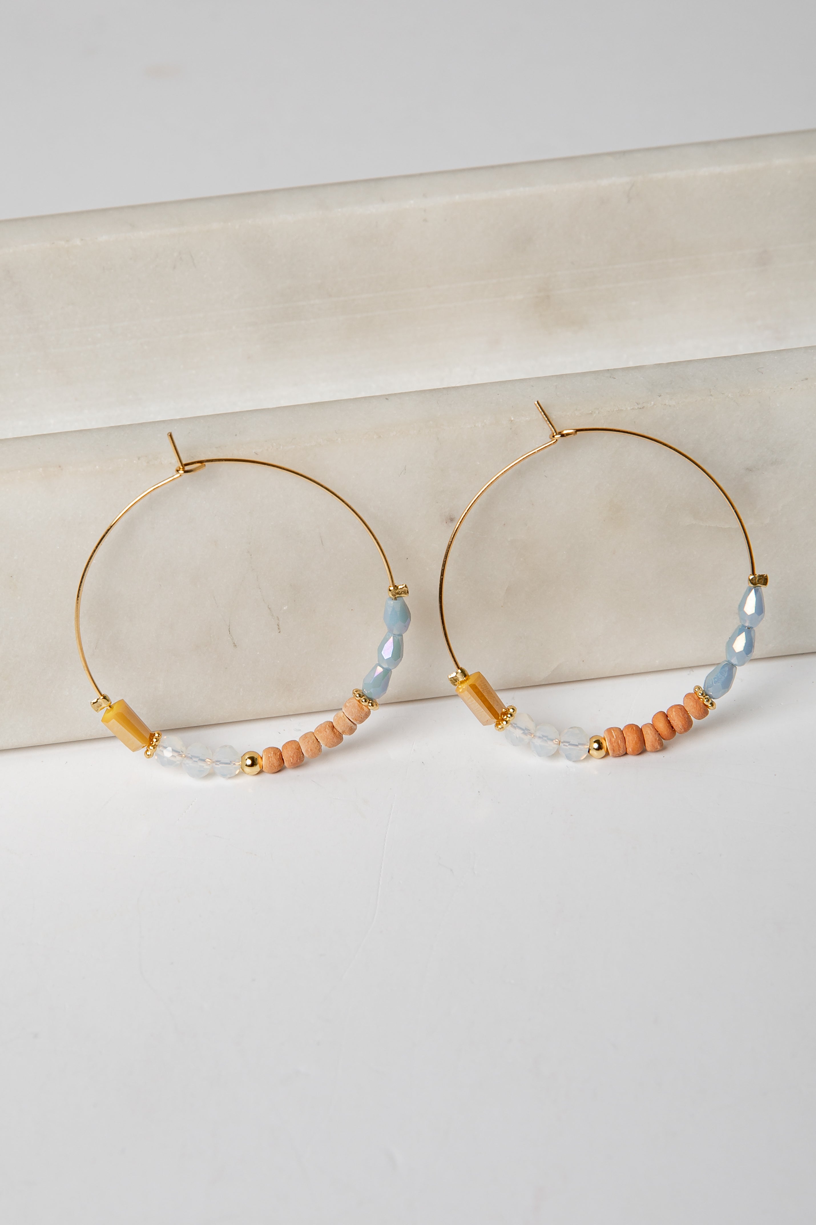 Hoop earrings with beaded accents on a light background
