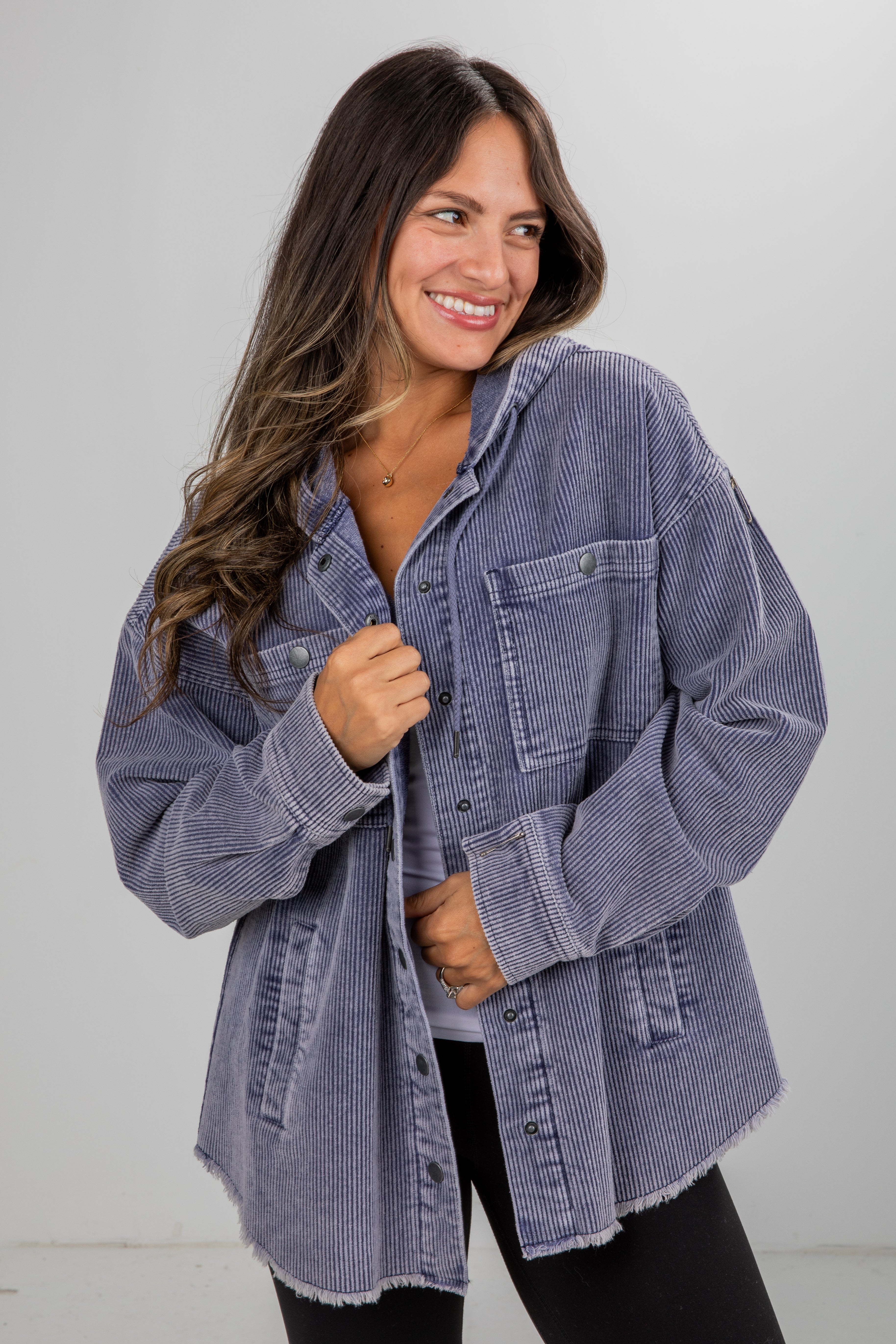 Woman wearing a blue denim jacket against a white background