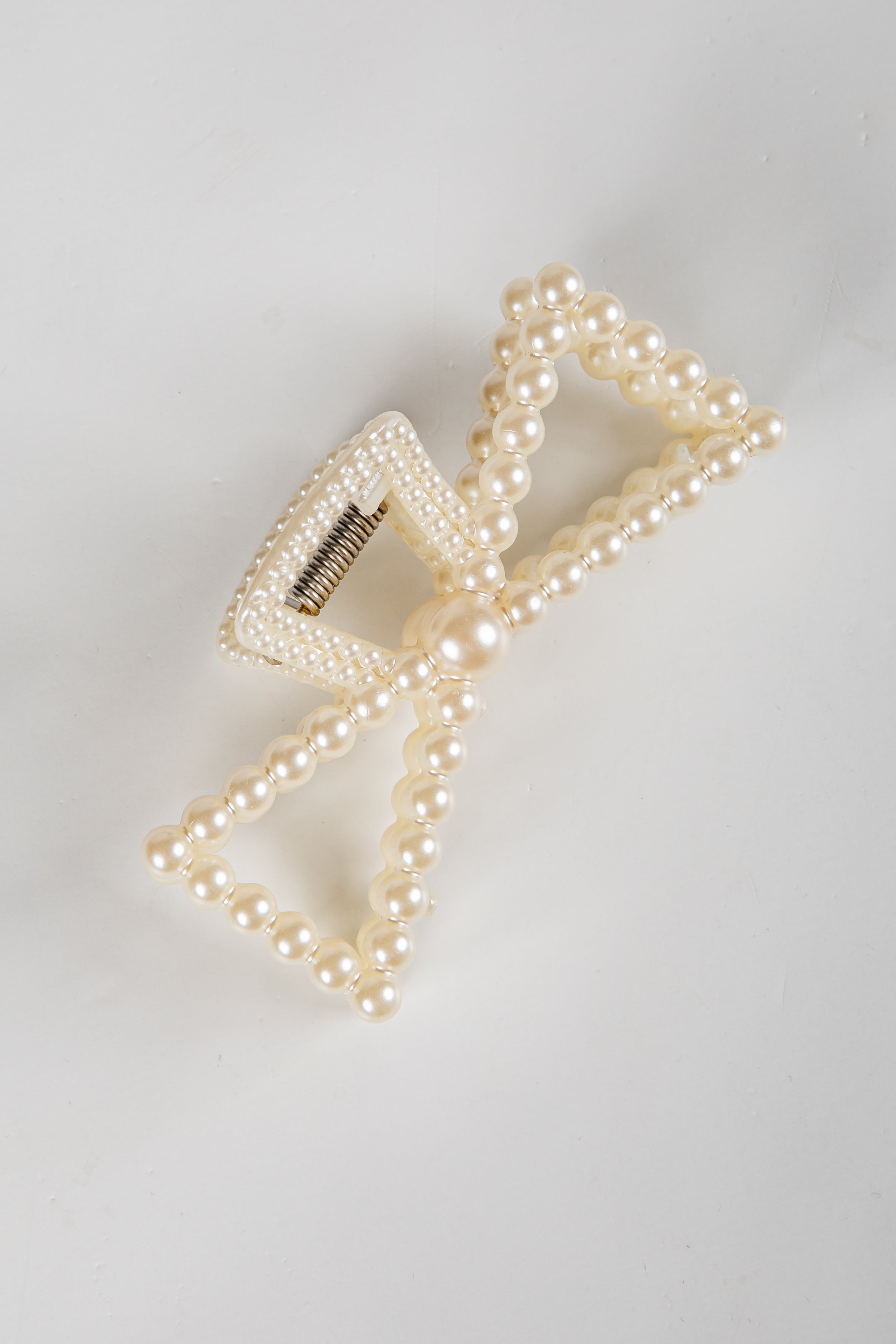 Pearl hair clip on a light gray background