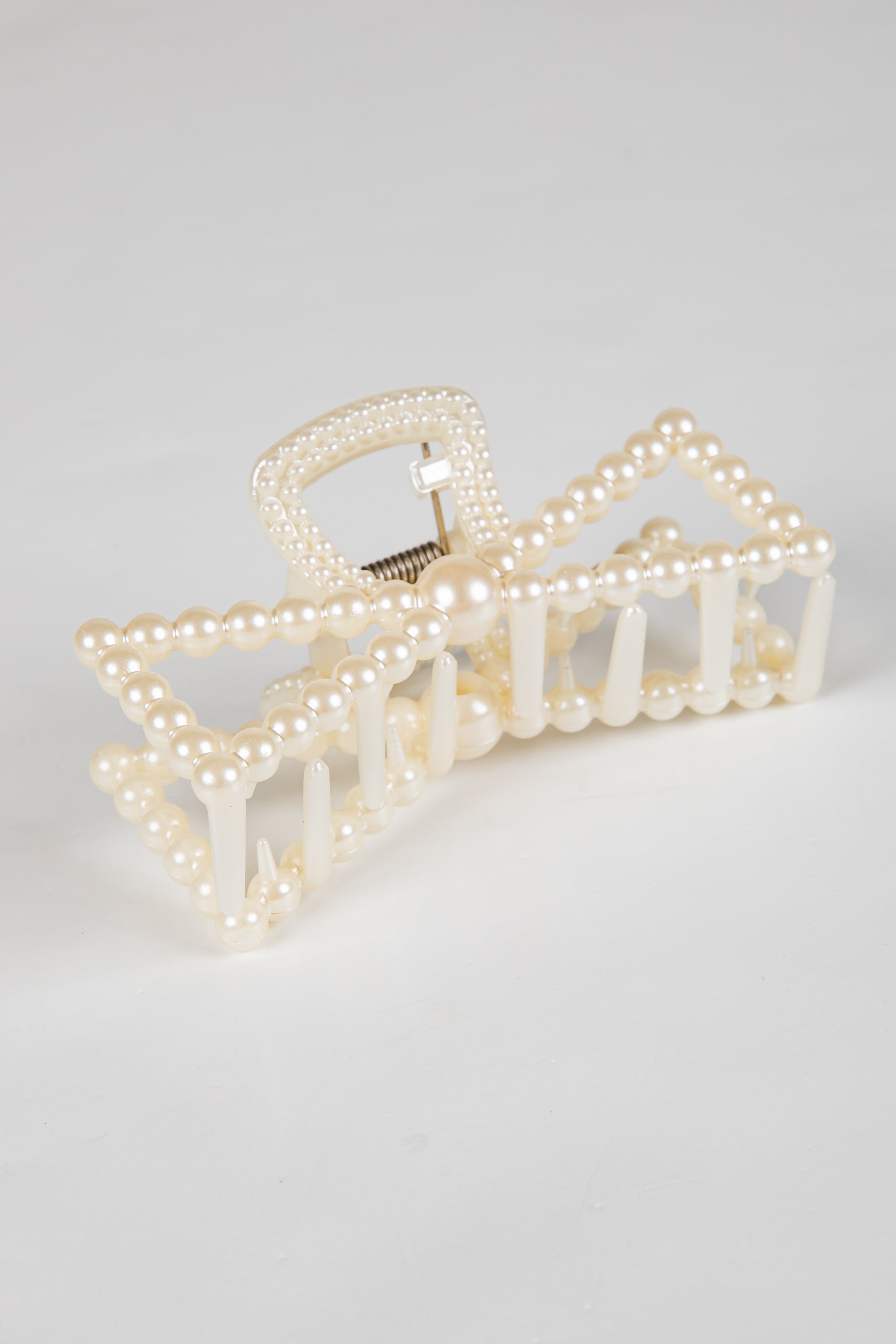 Pearl hair clip on a light gray background