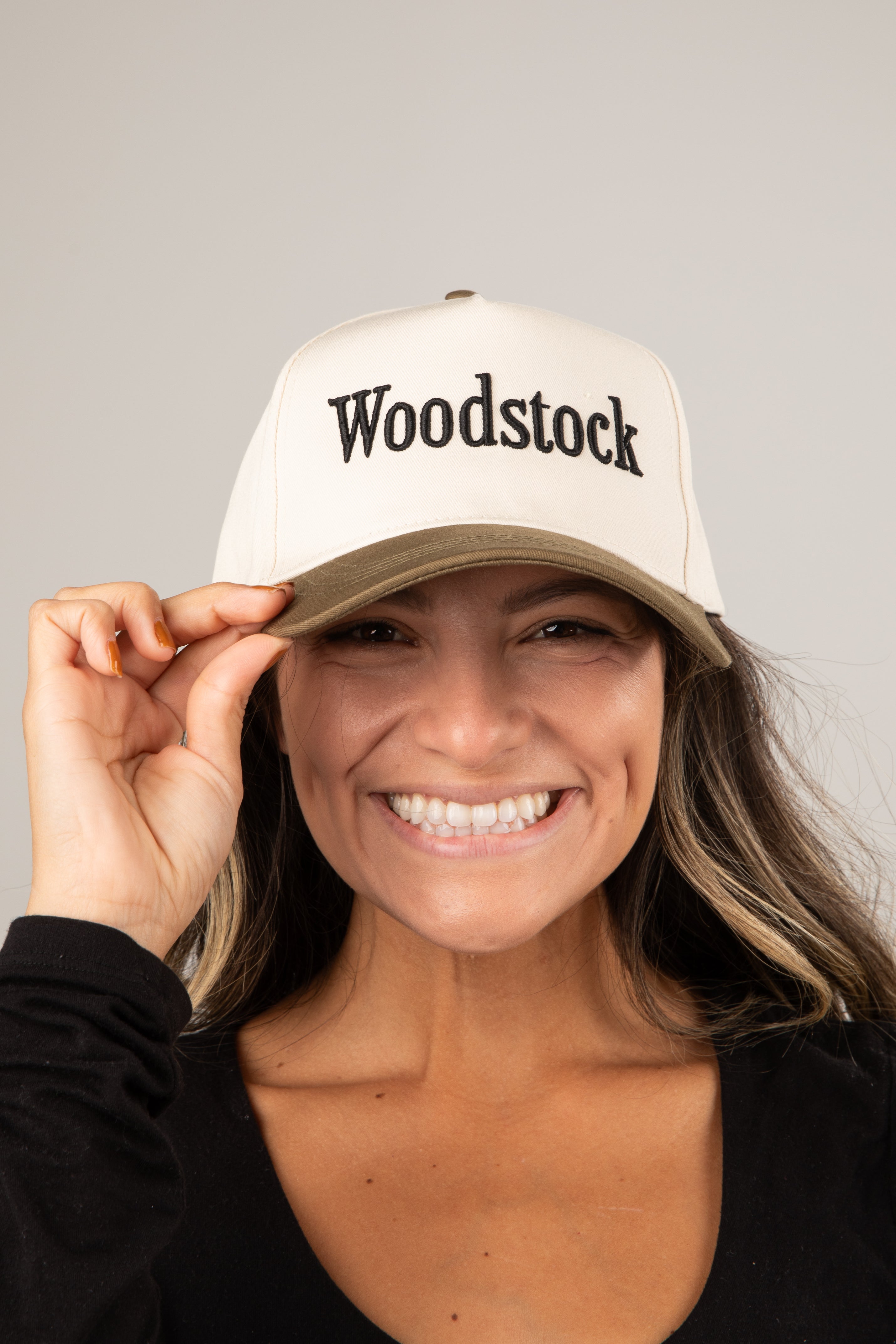 Person wearing a white cap with &