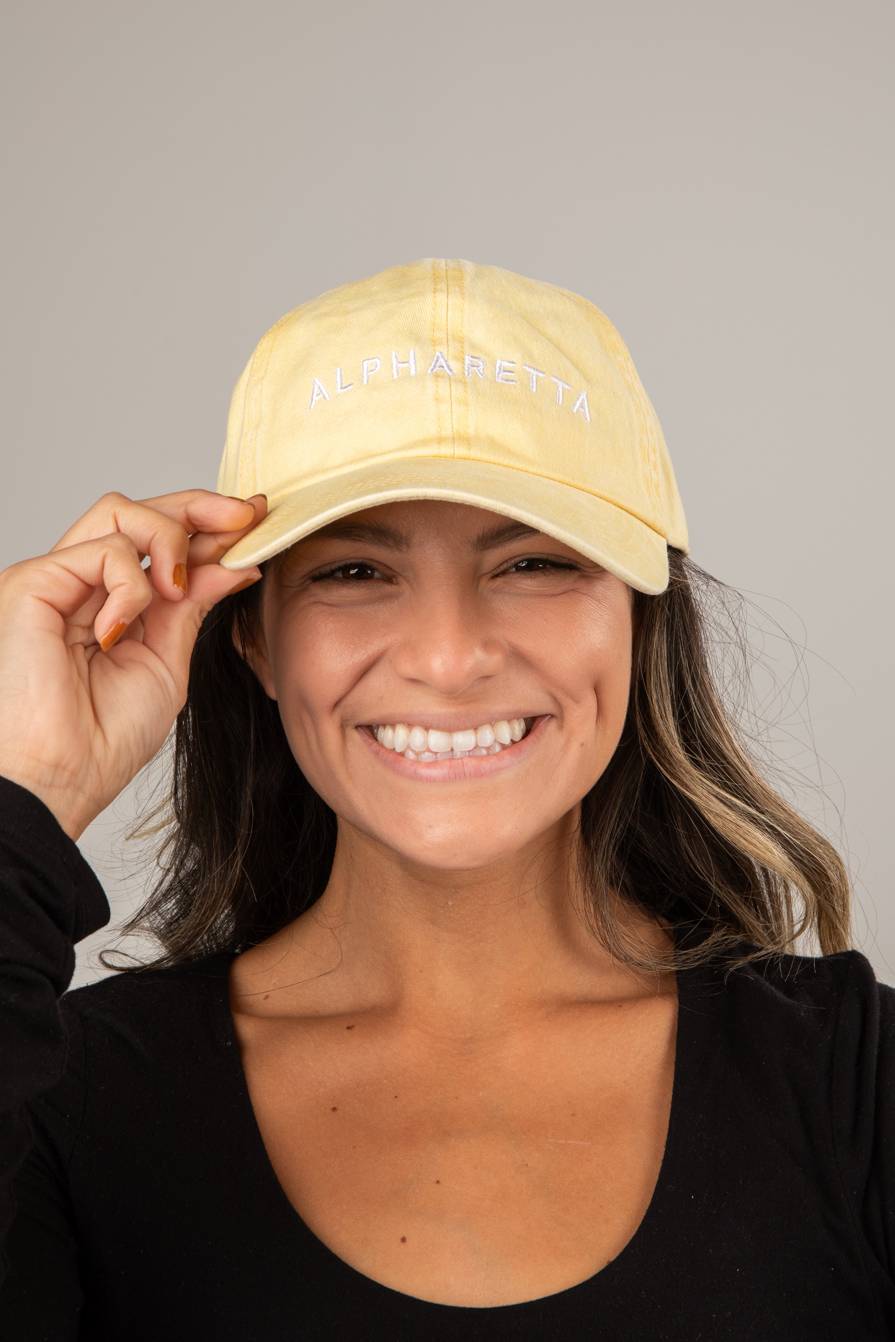 Woman wearing a yellow cap with &