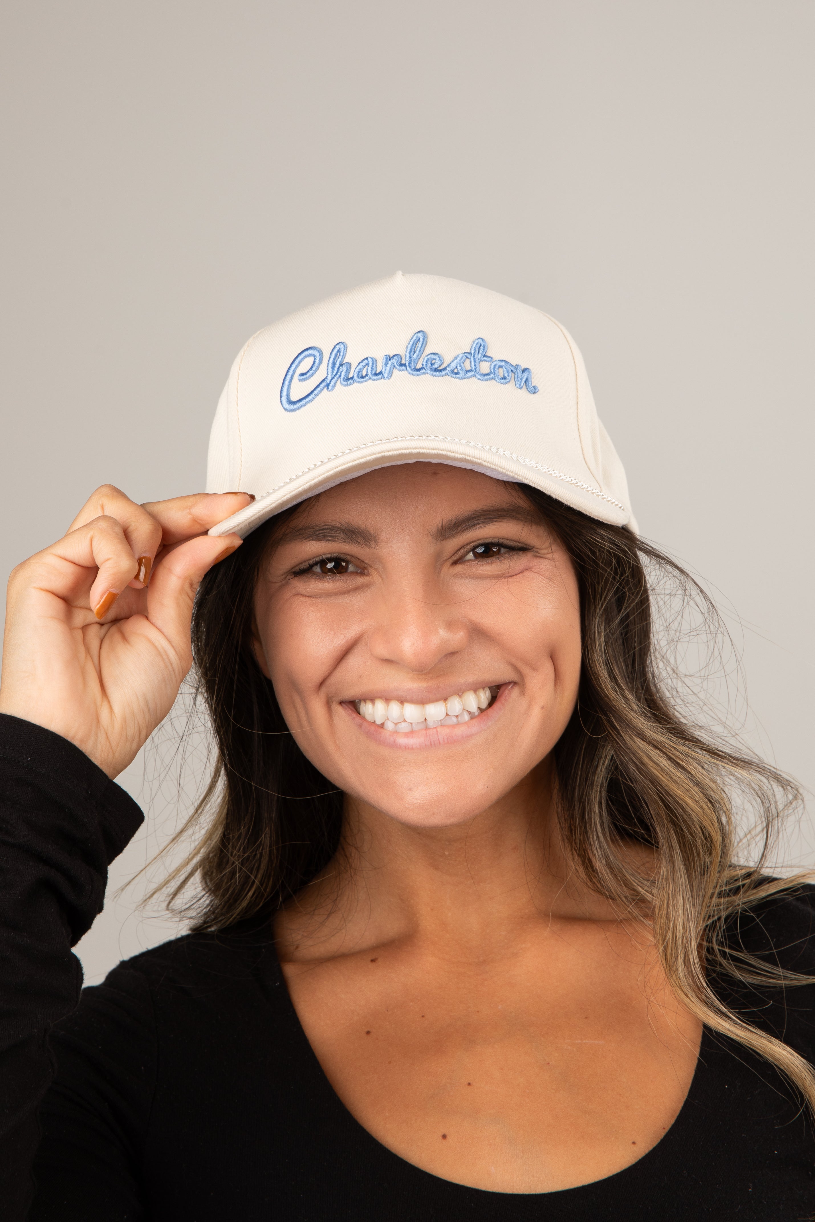 Woman wearing a white cap with &