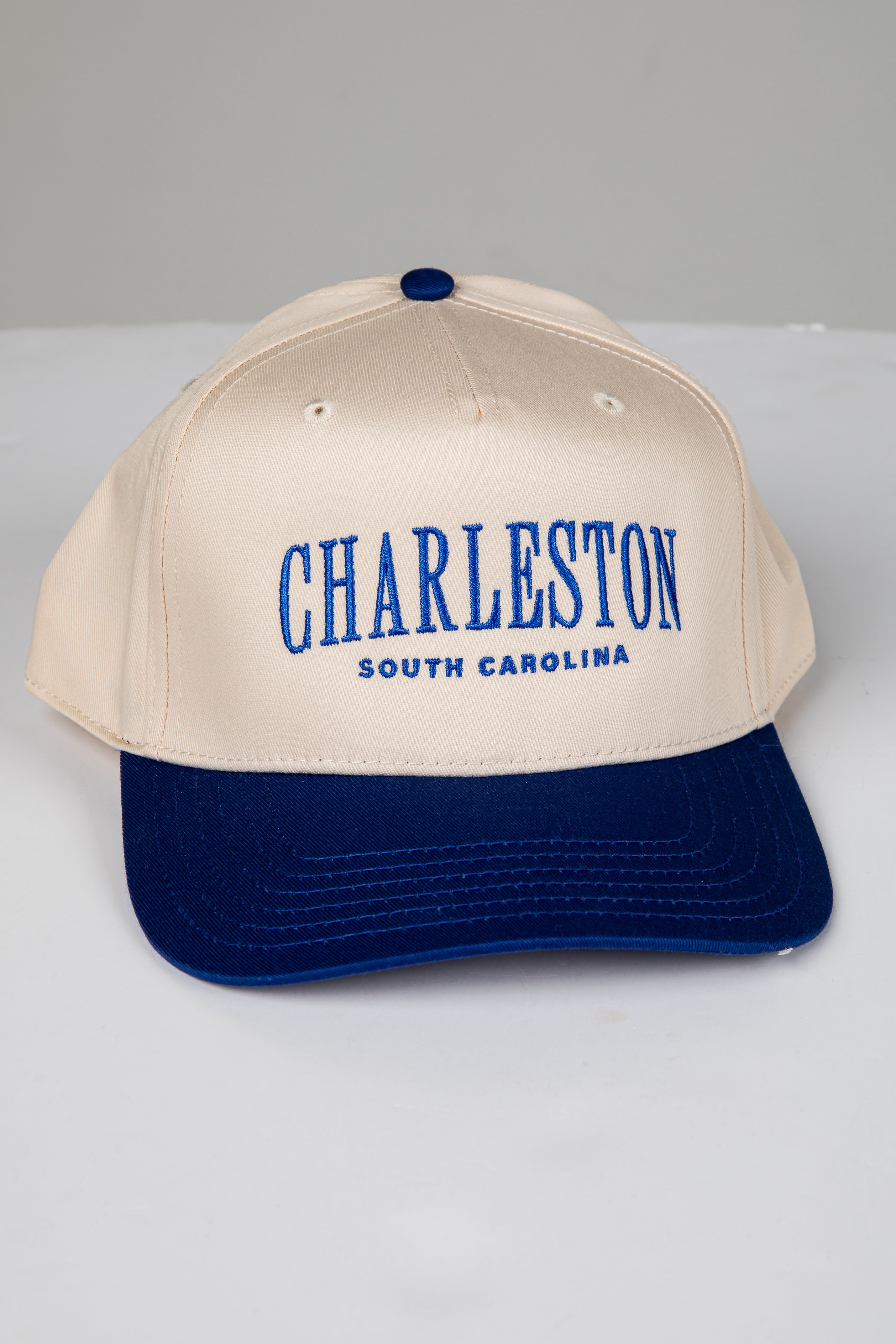 Beige and navy cap with &
