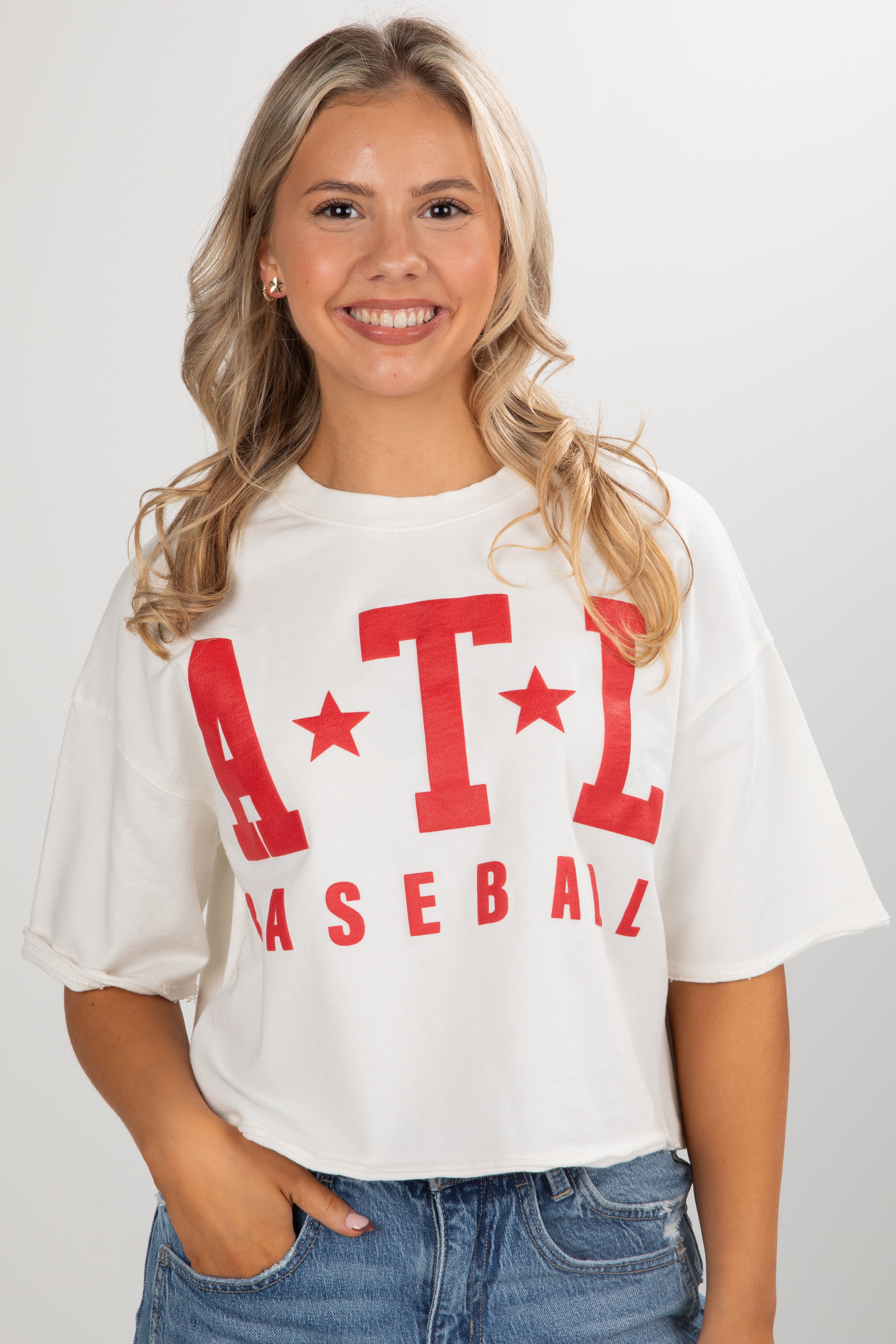 Woman wearing a white t-shirt with red &