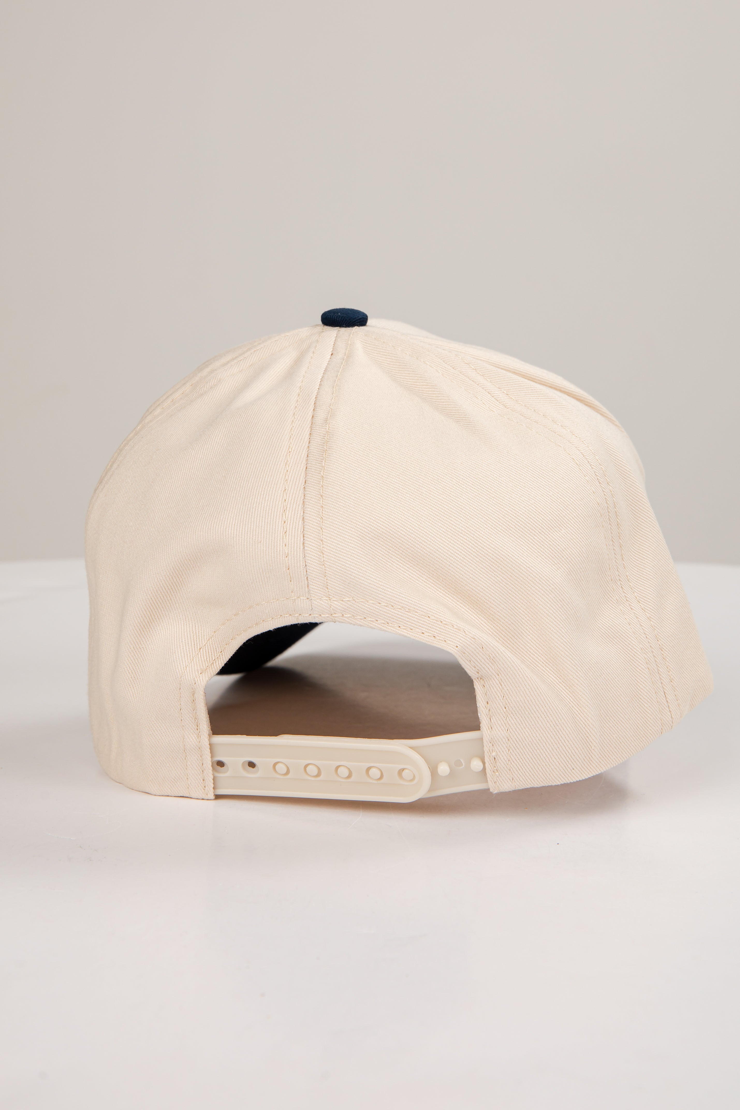 Beige baseball cap on a light gray background