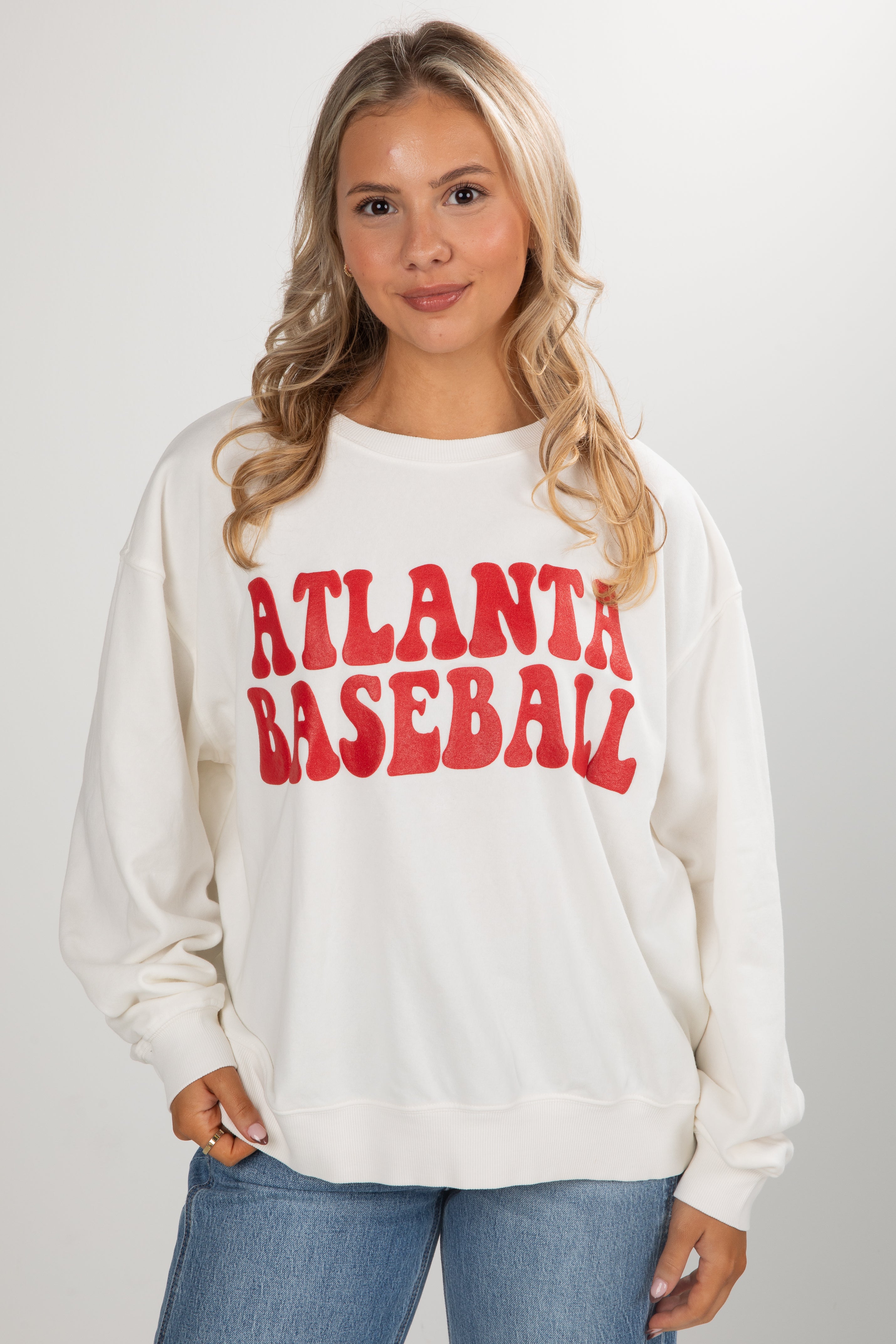 Woman wearing a white sweatshirt with &