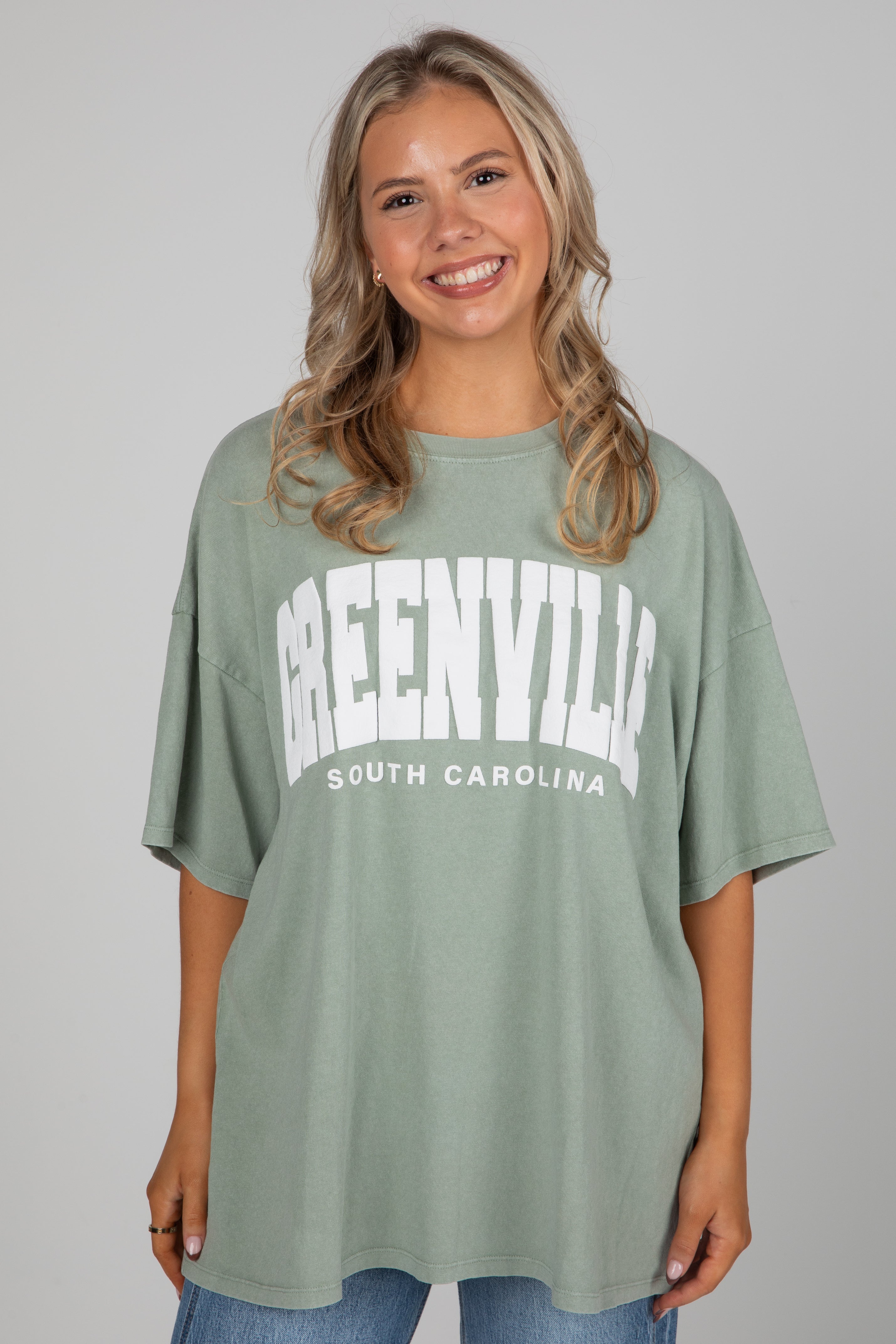 Woman wearing a green t-shirt with &