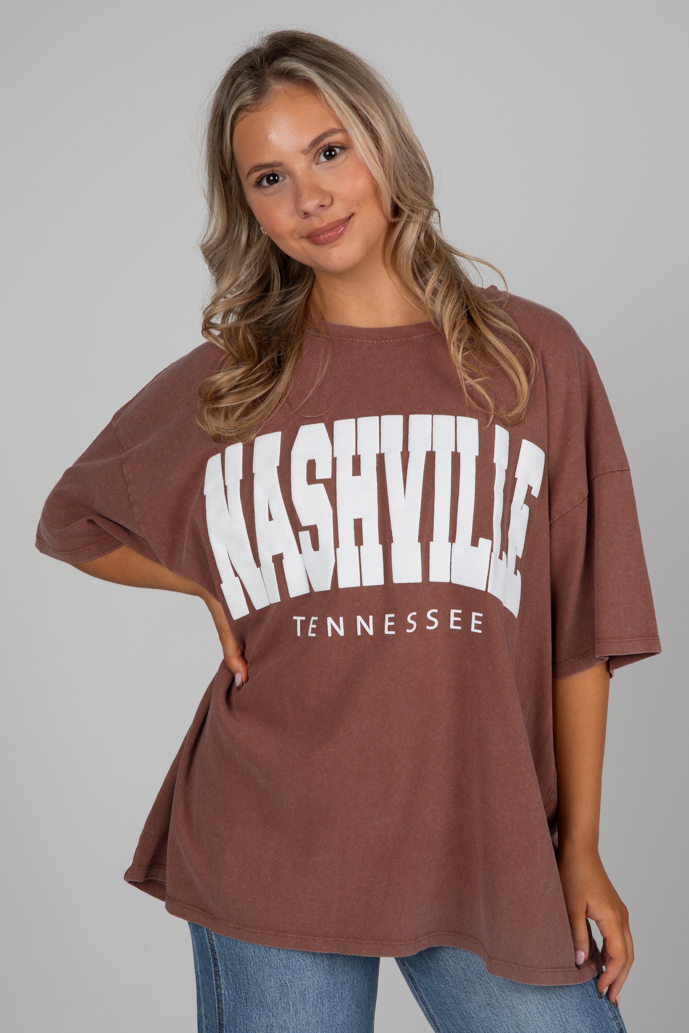 Woman wearing a brown t-shirt with &