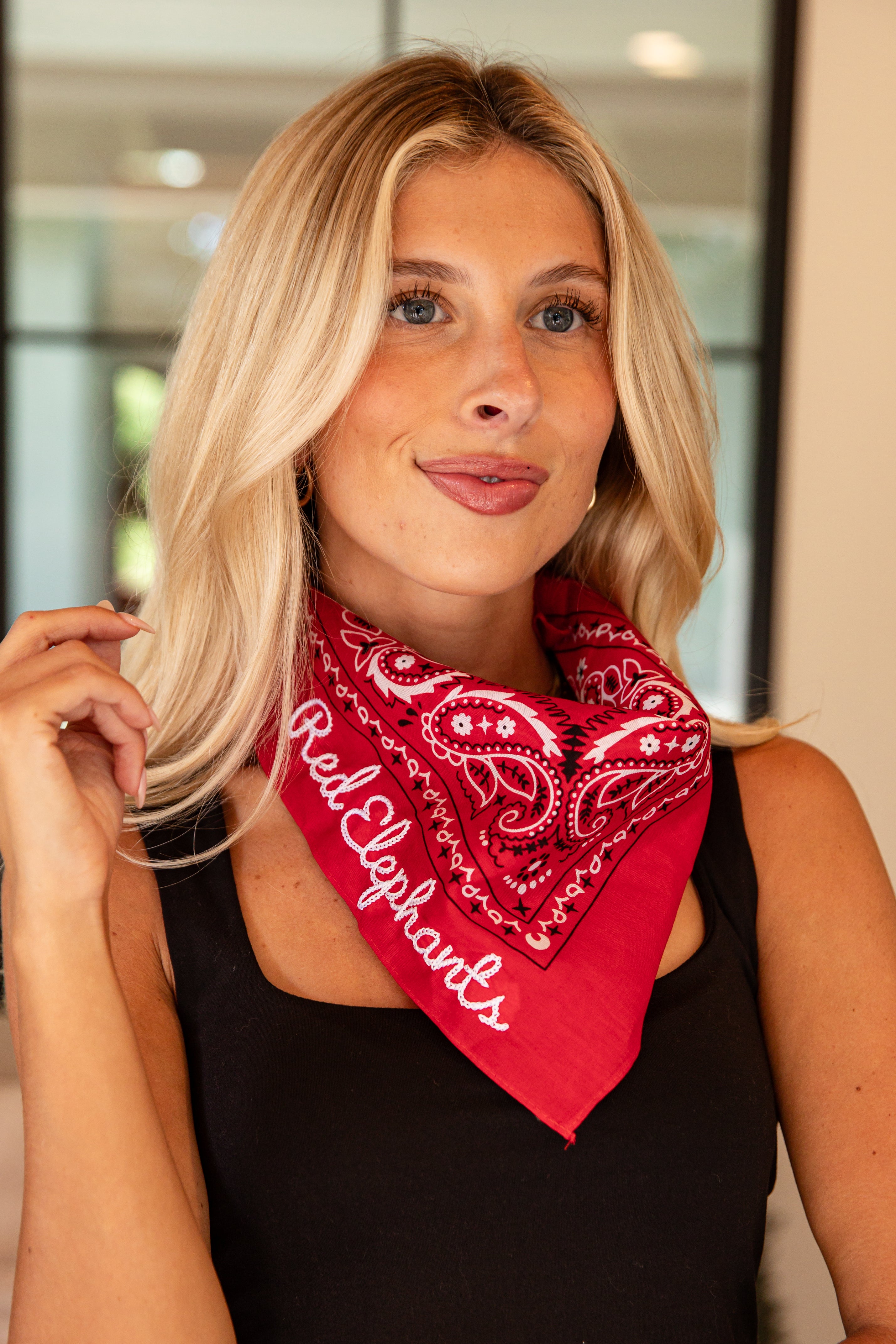 Woman wearing a red bandana with &