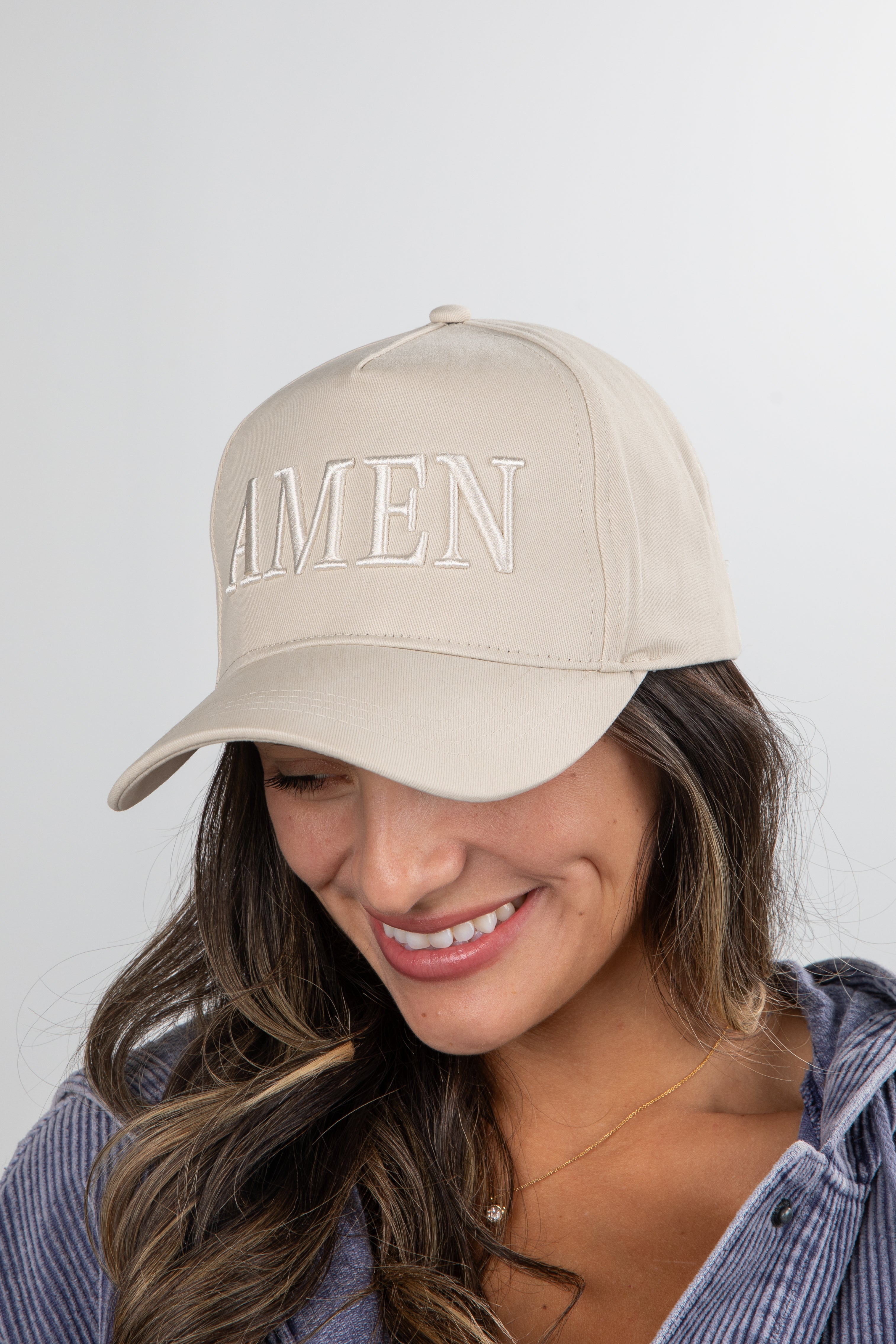 Woman wearing a beige cap with &