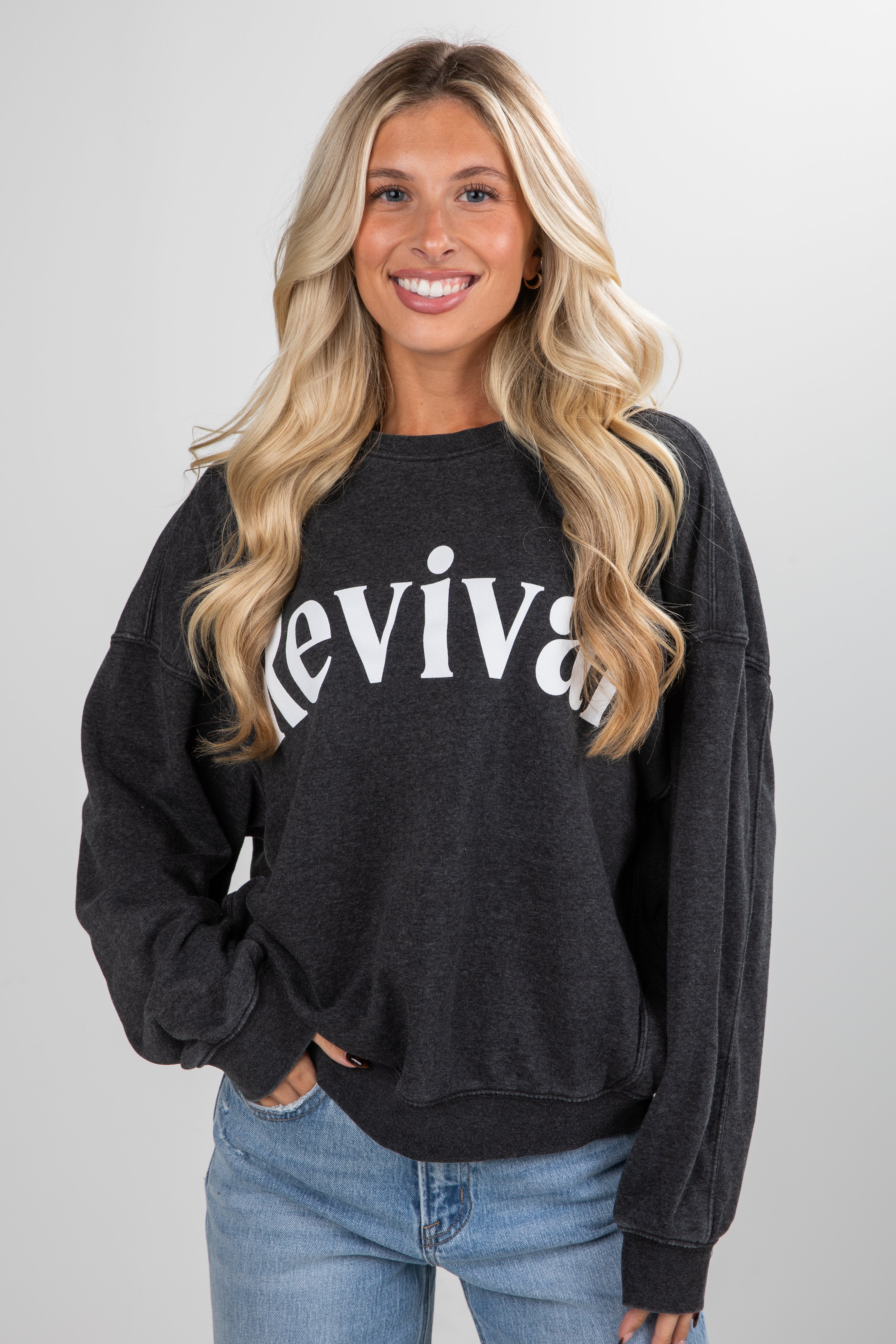 Woman wearing a black sweatshirt with &