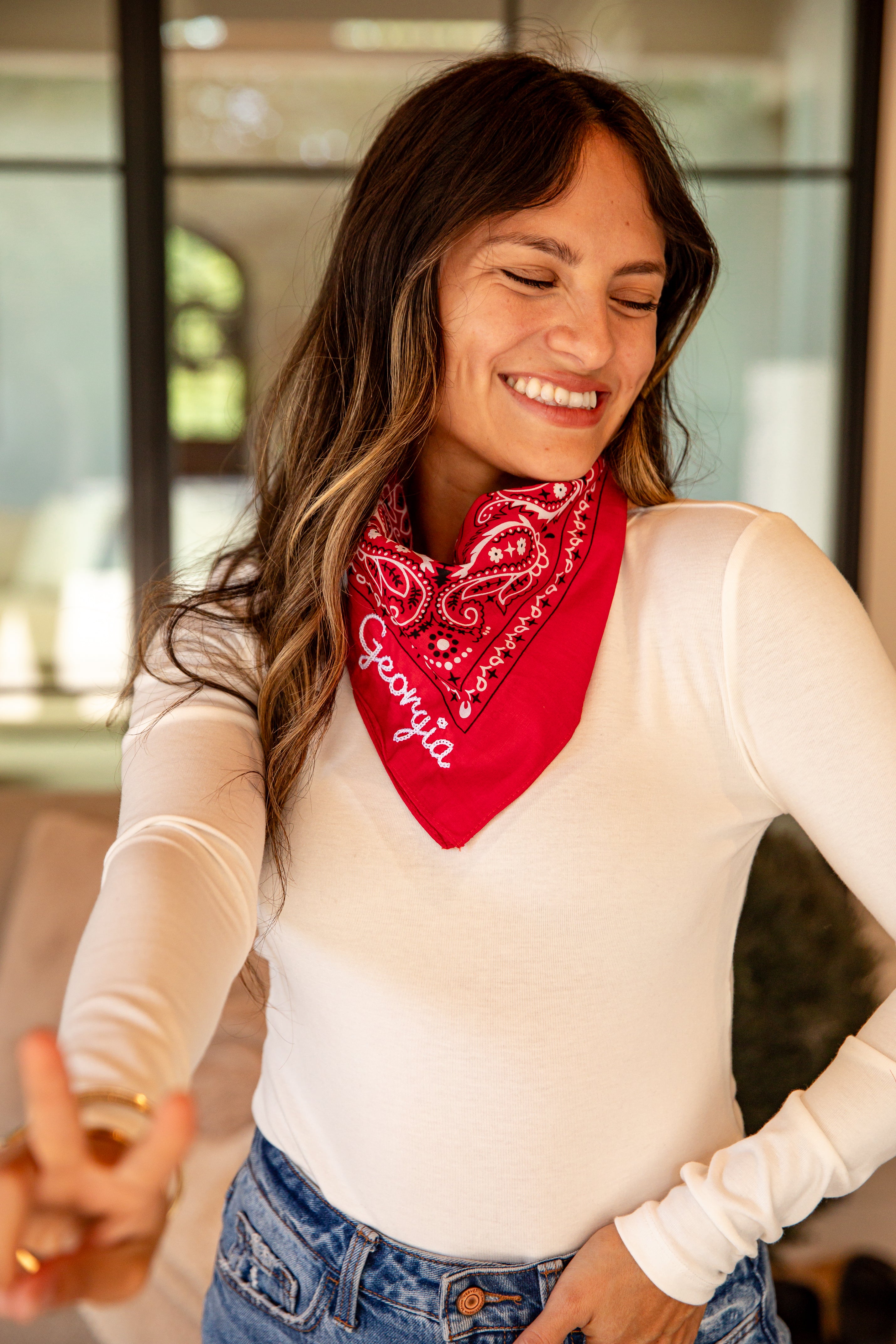 Woman wearing a red bandana with &