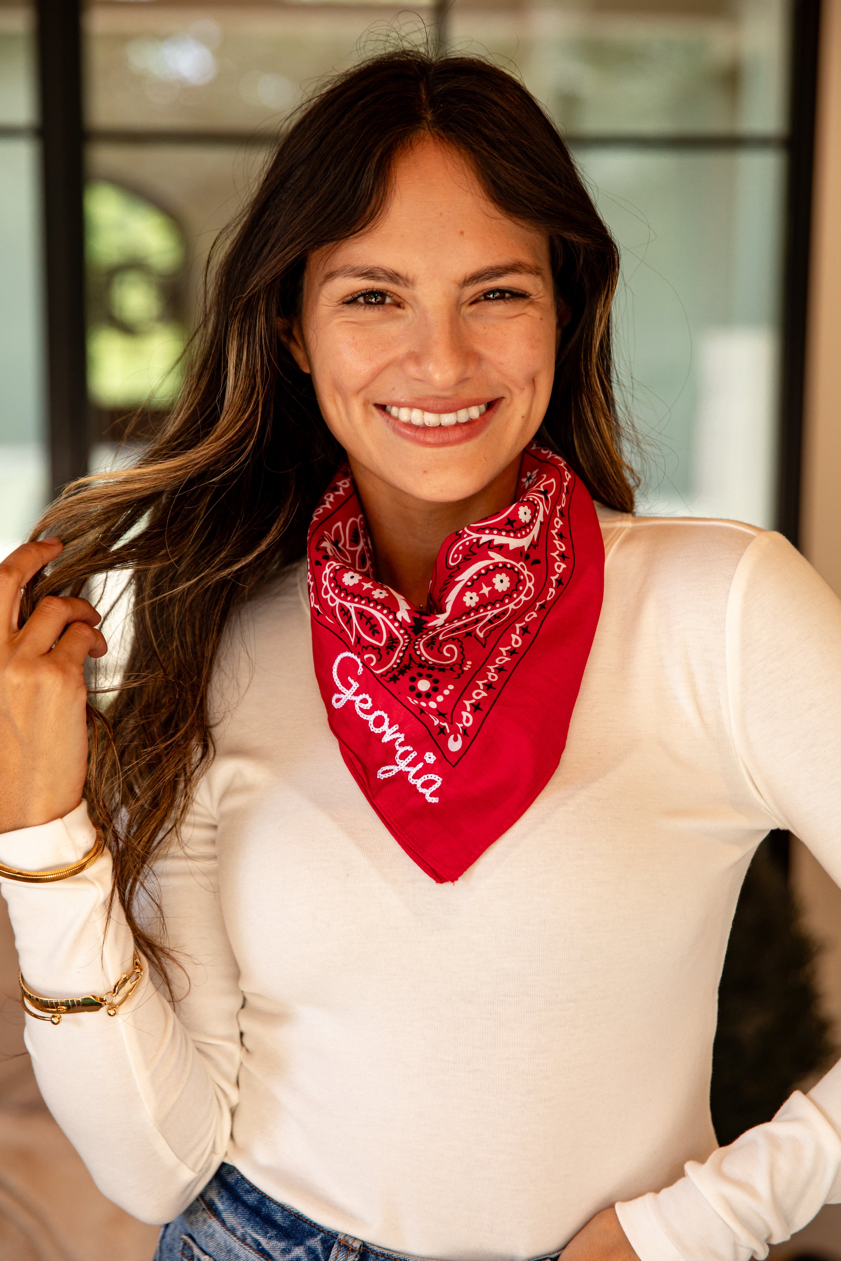 Woman wearing a red bandana with &