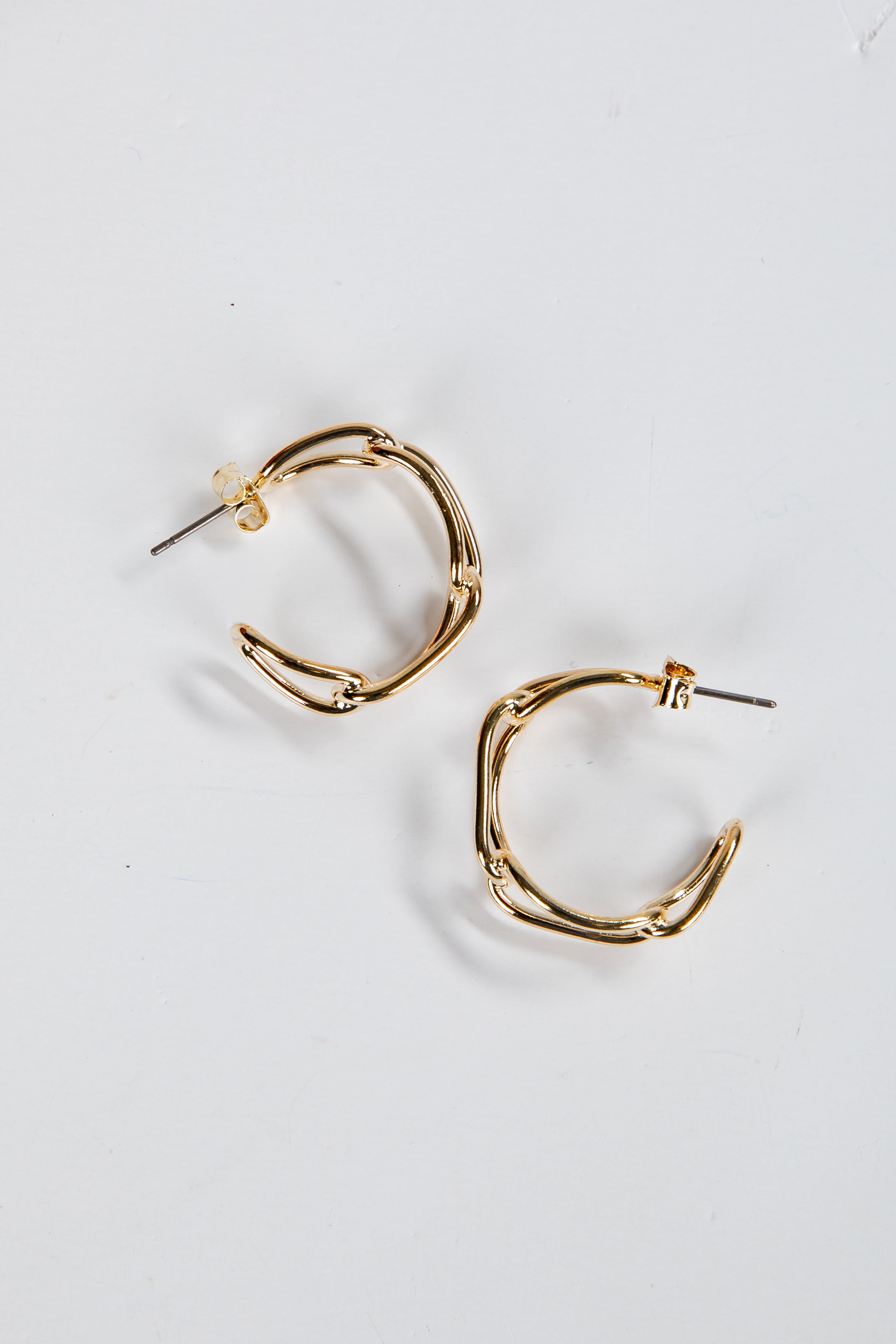Gold hoop earrings on a white background