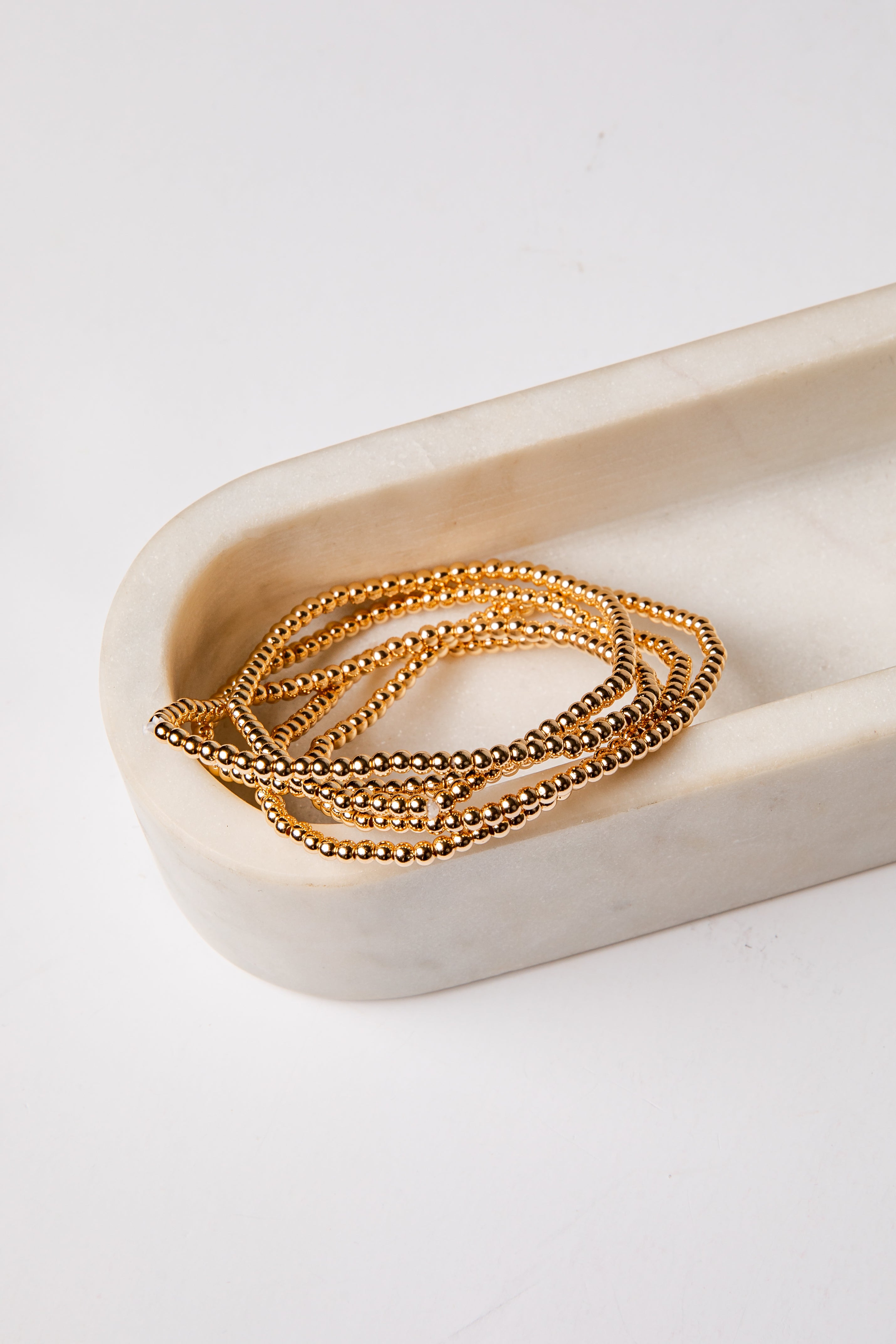 set of 5 gold beaded bracelets