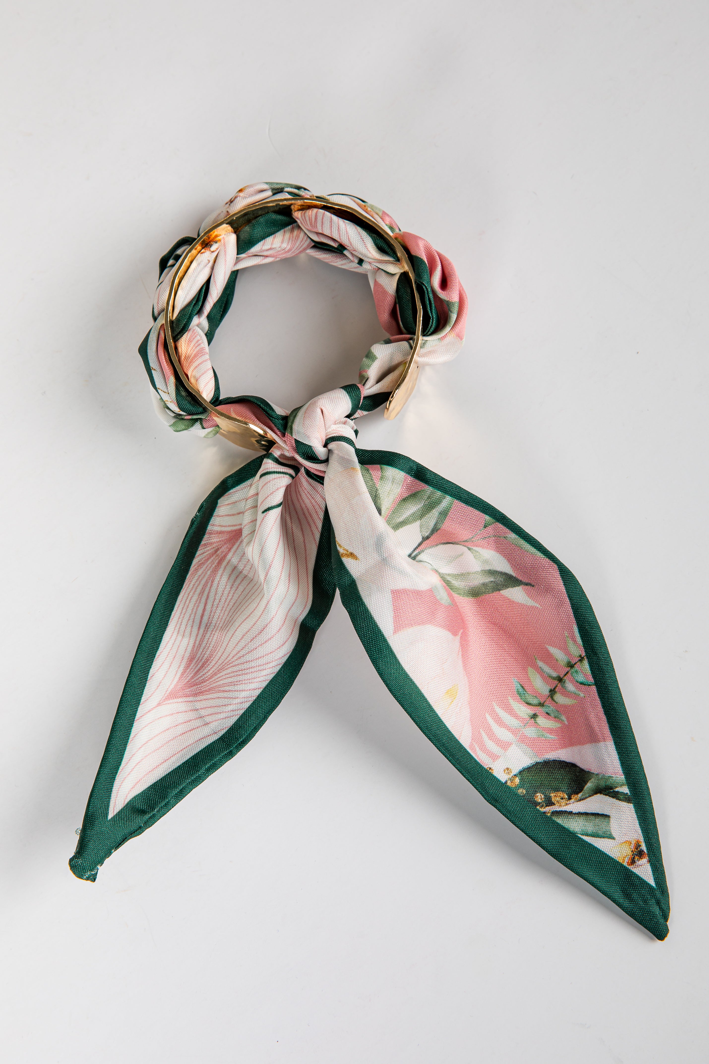 Floral headband with green accents on a light gray background