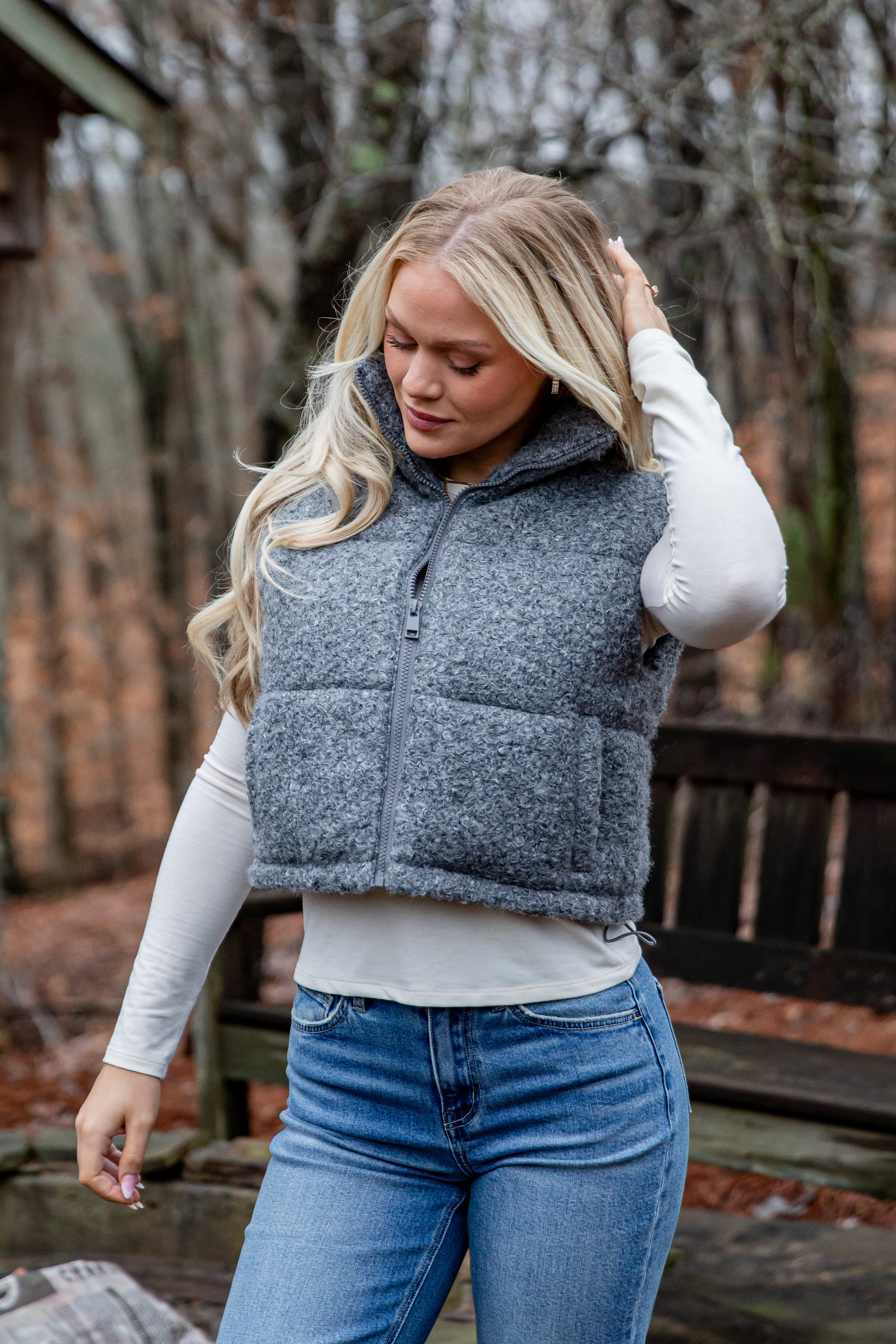 Woman wearing a gray puffer vest outdoors