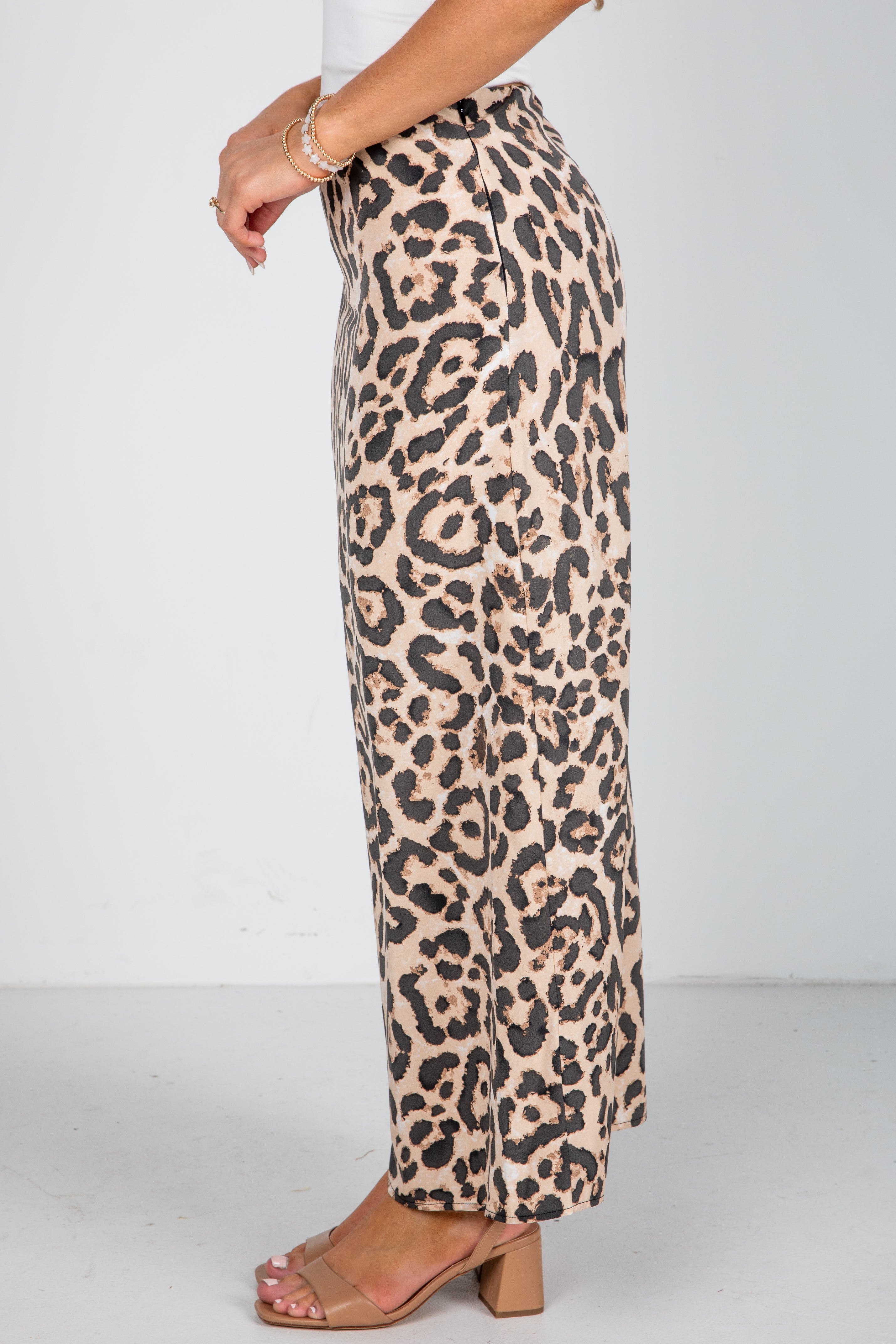Leopard print pants worn by a person on a white background