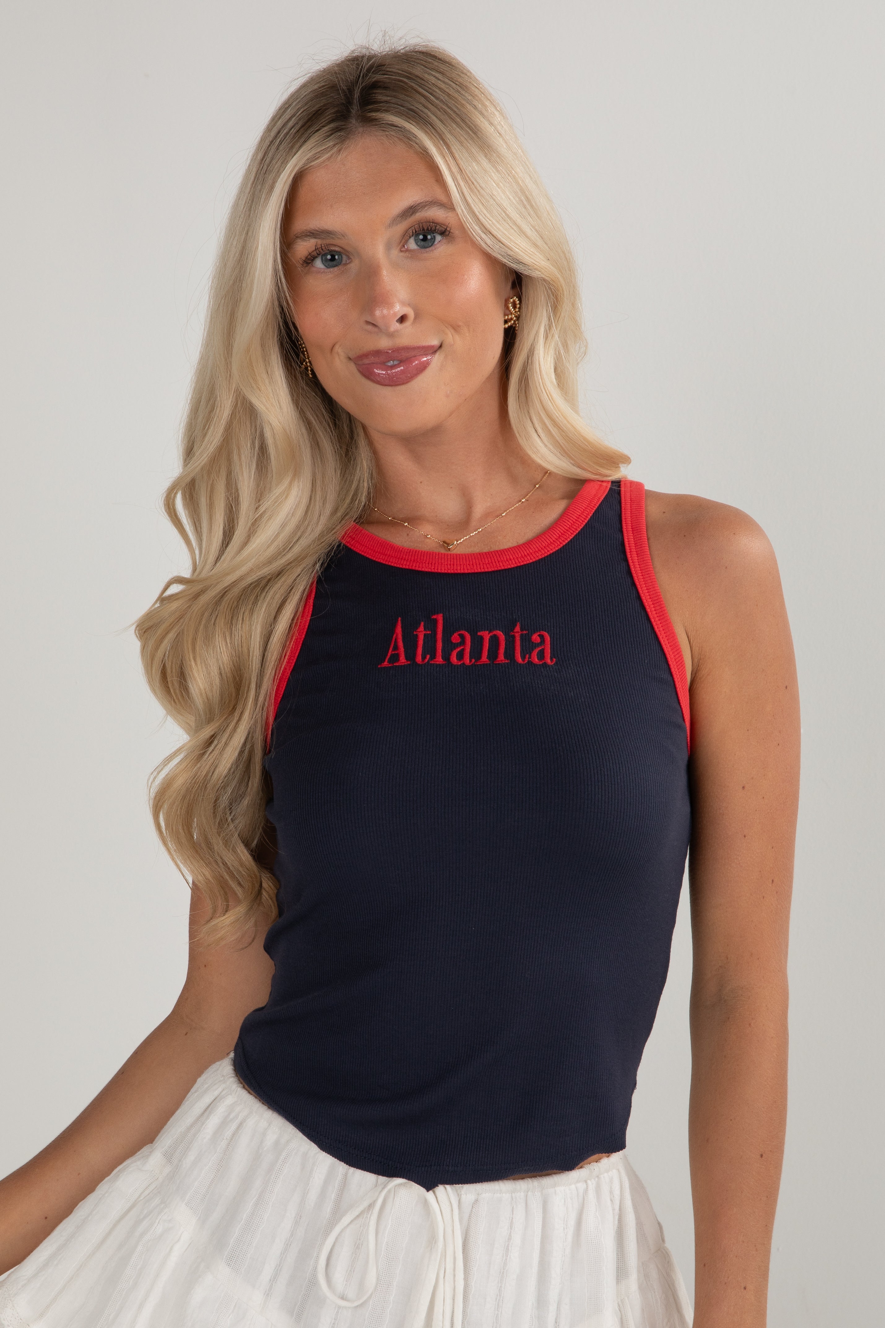 Woman wearing a black tank top with &