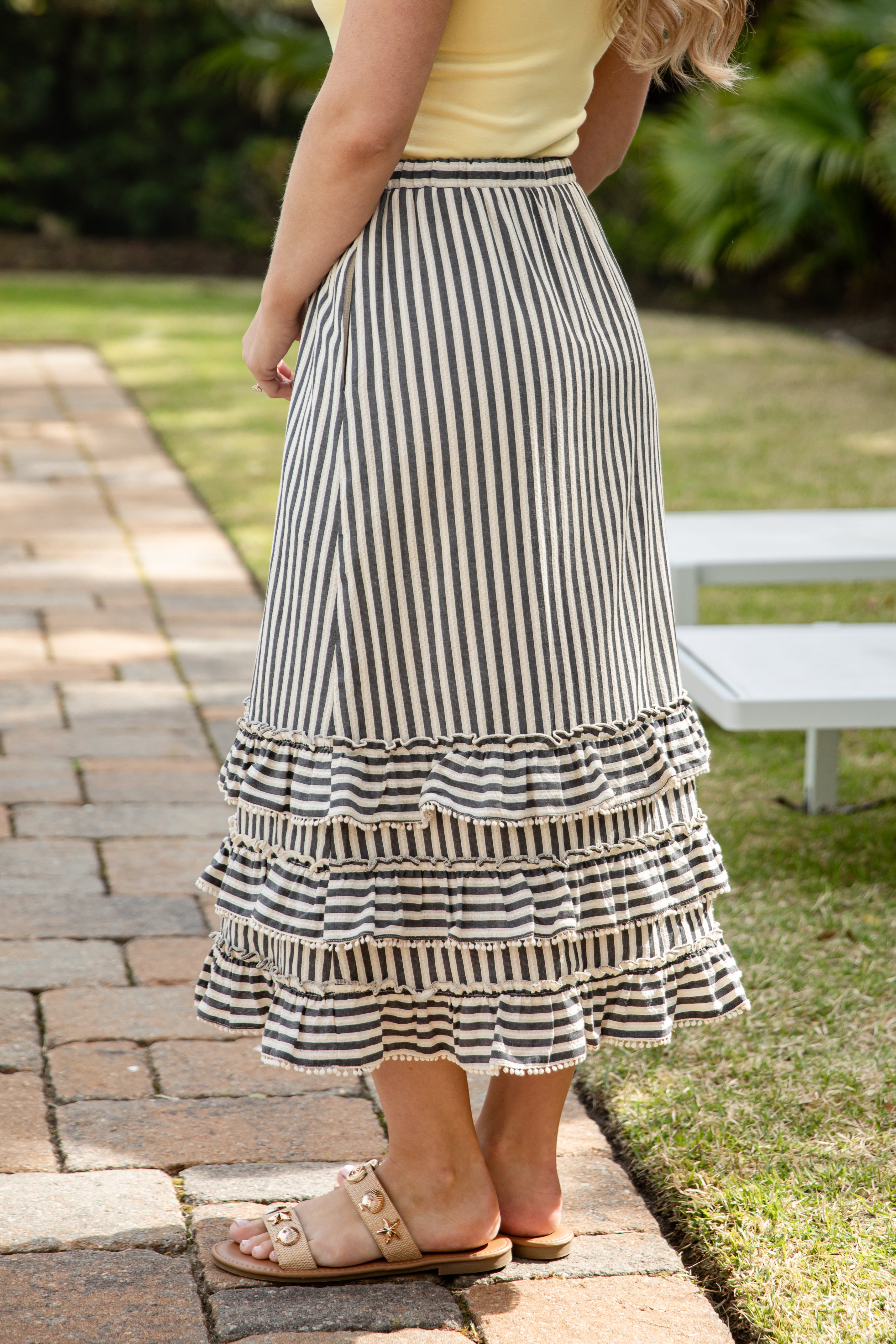 Woman wearing striped maxi skirt.