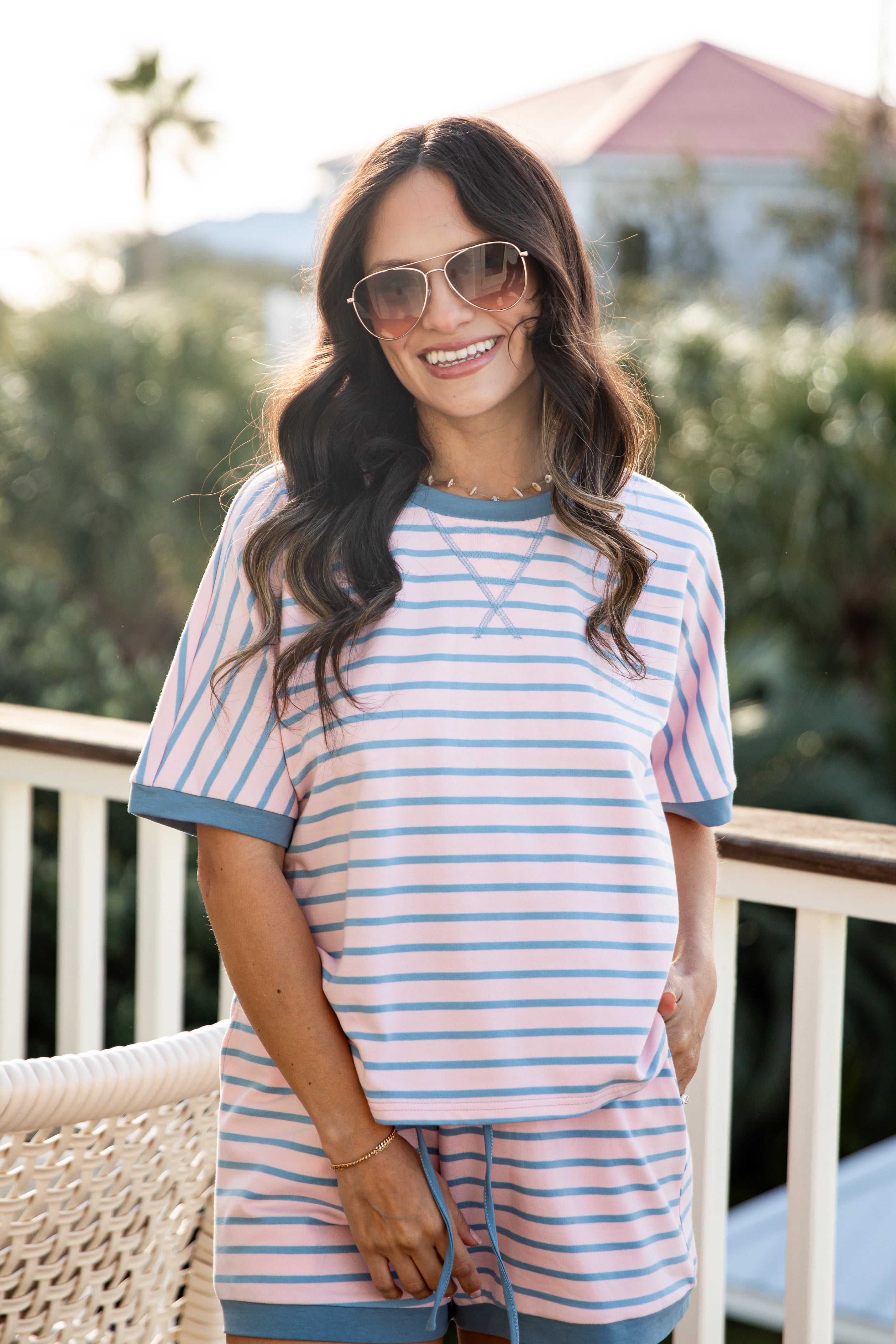 Woman wearing a striped dress and sunglasses outdoors