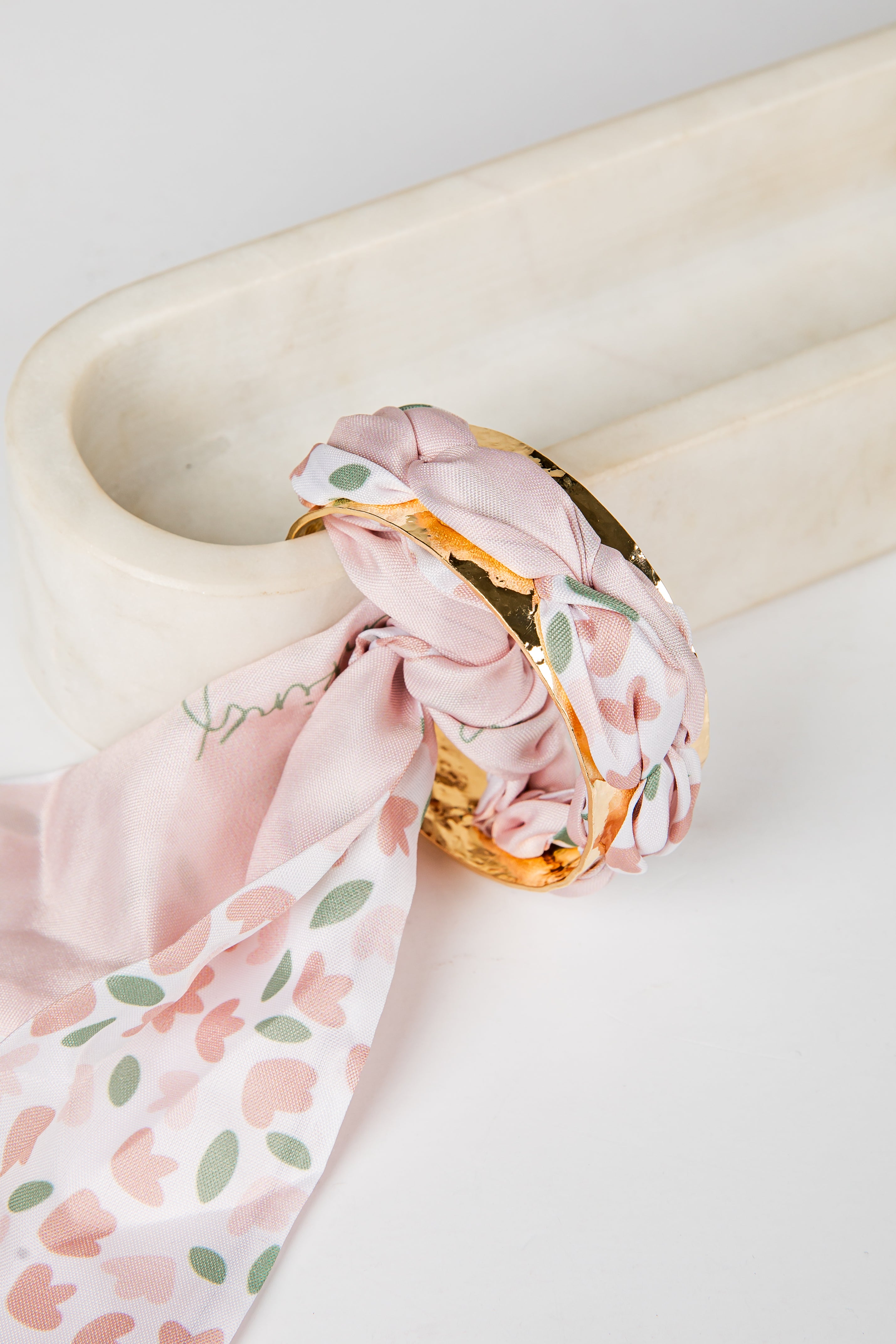 Pink floral bracelet on a marble surface