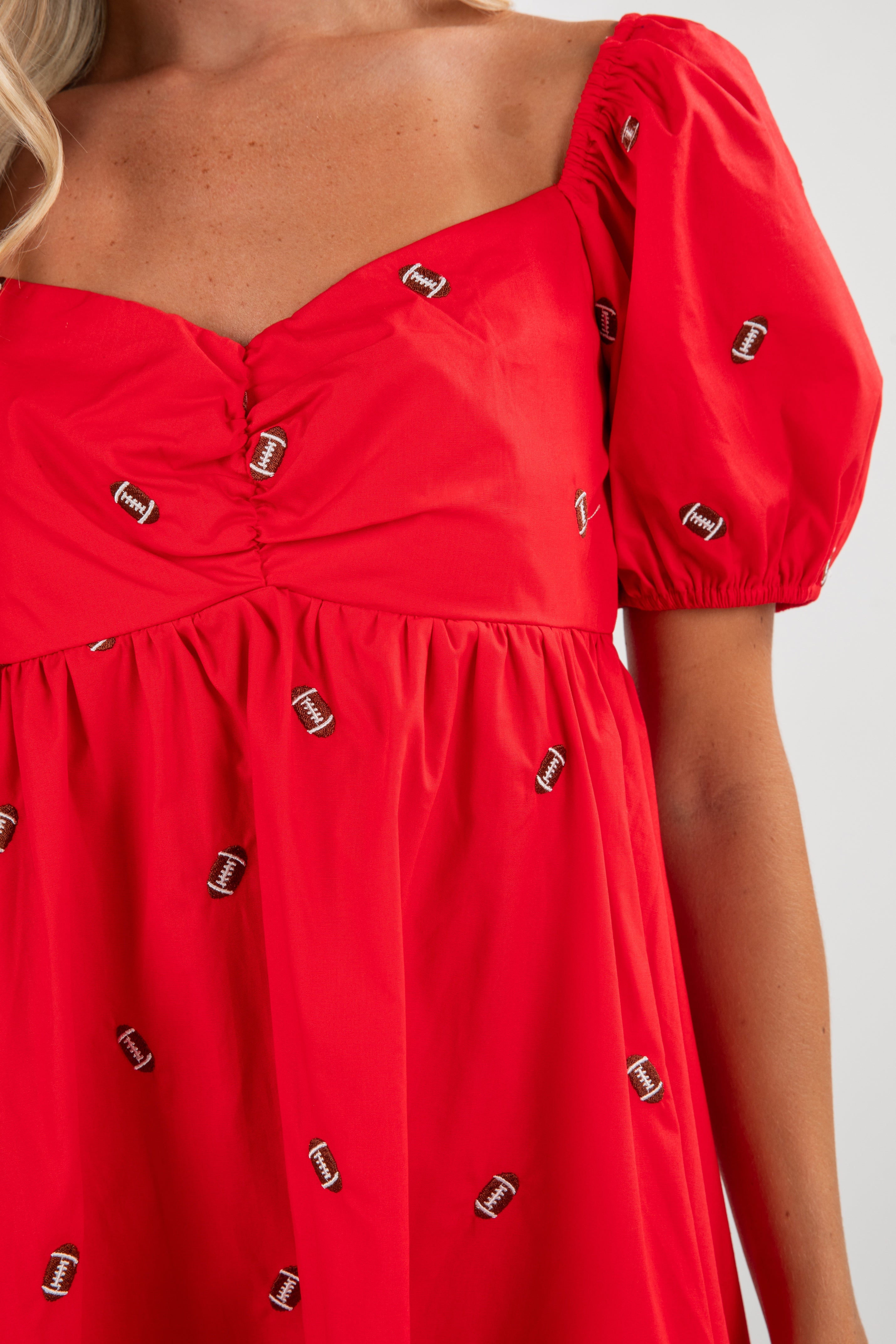 Red dress with decorative buttons on a white background