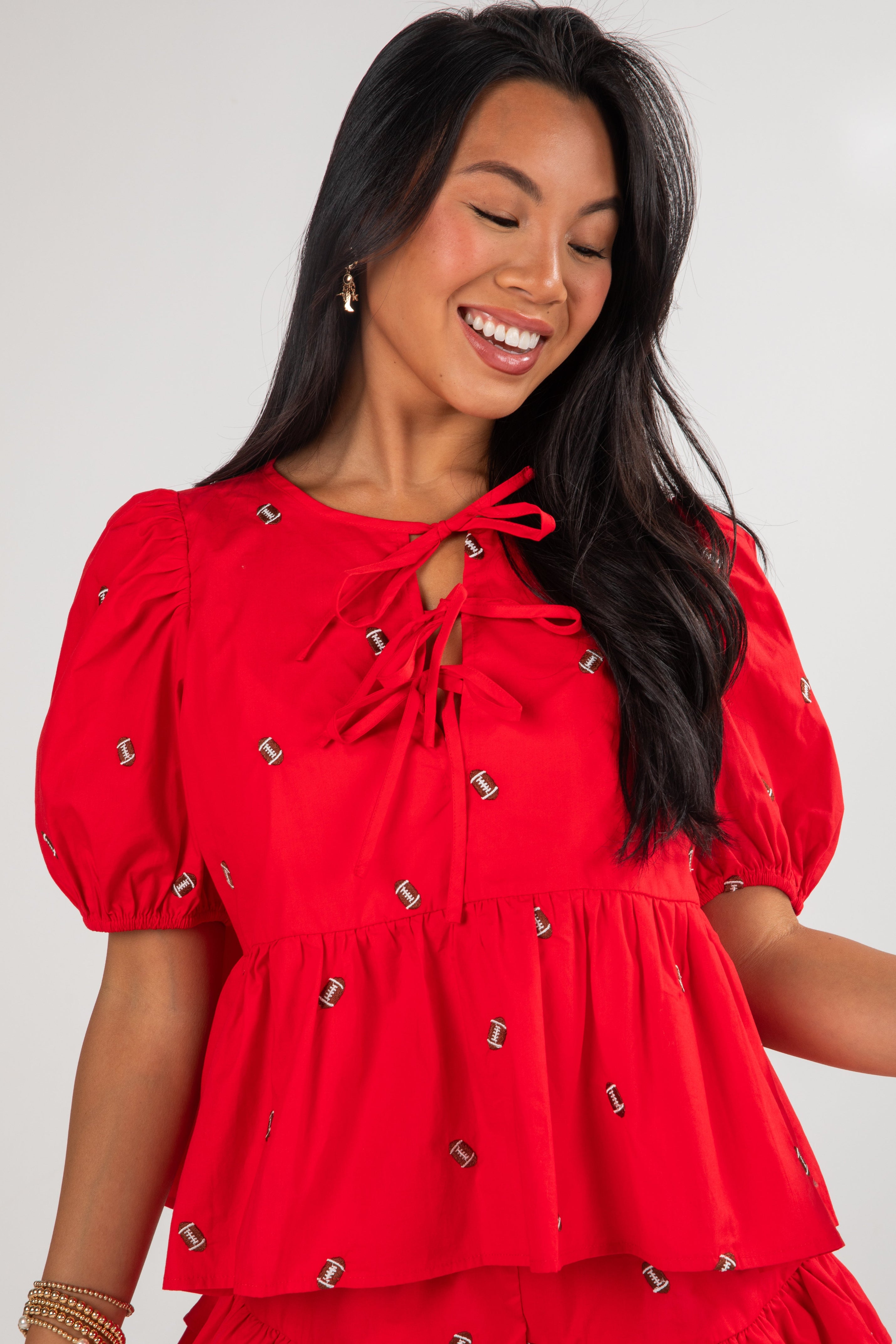 Woman wearing a red dress with decorative elements on a white background