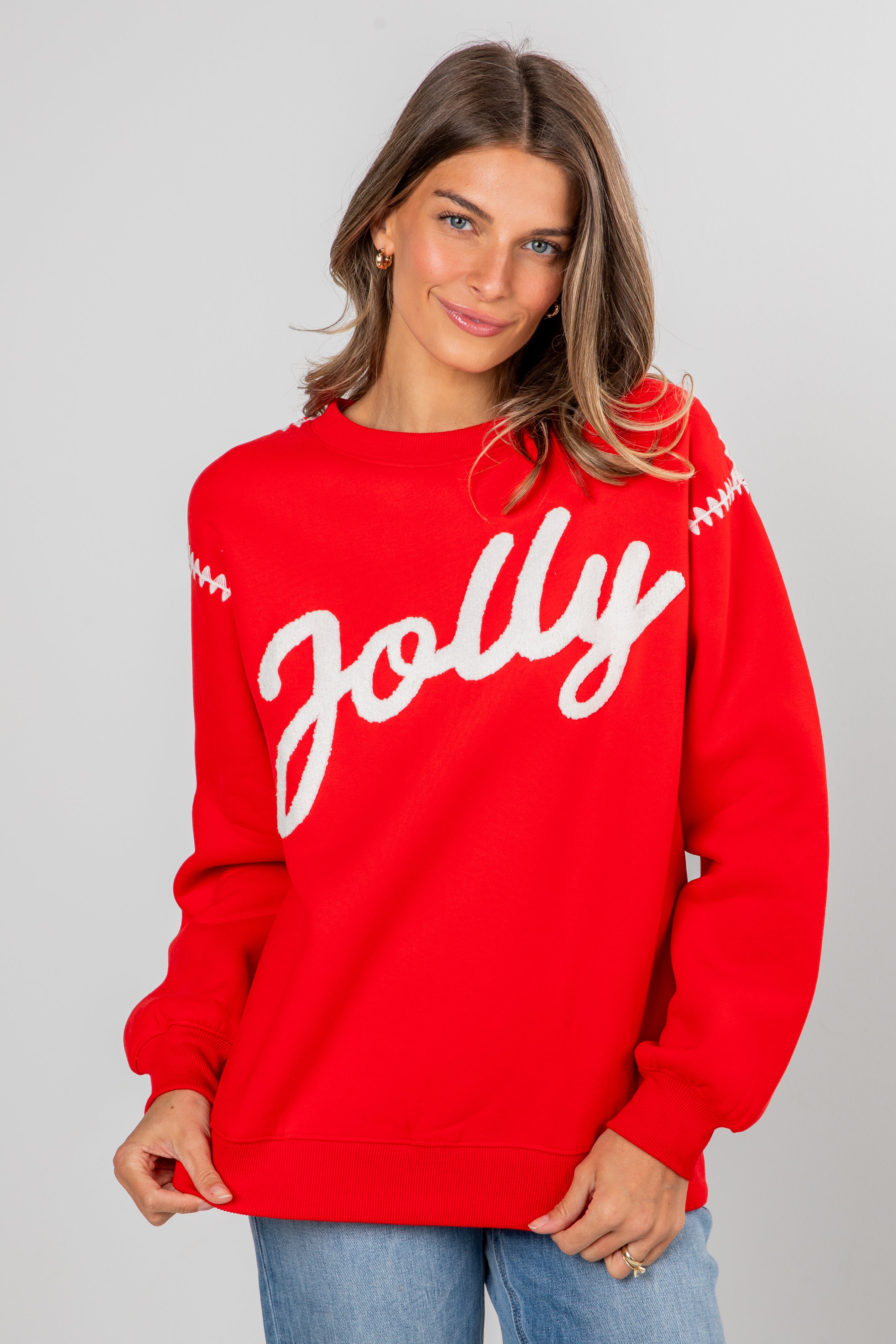 Woman wearing a red sweater with &