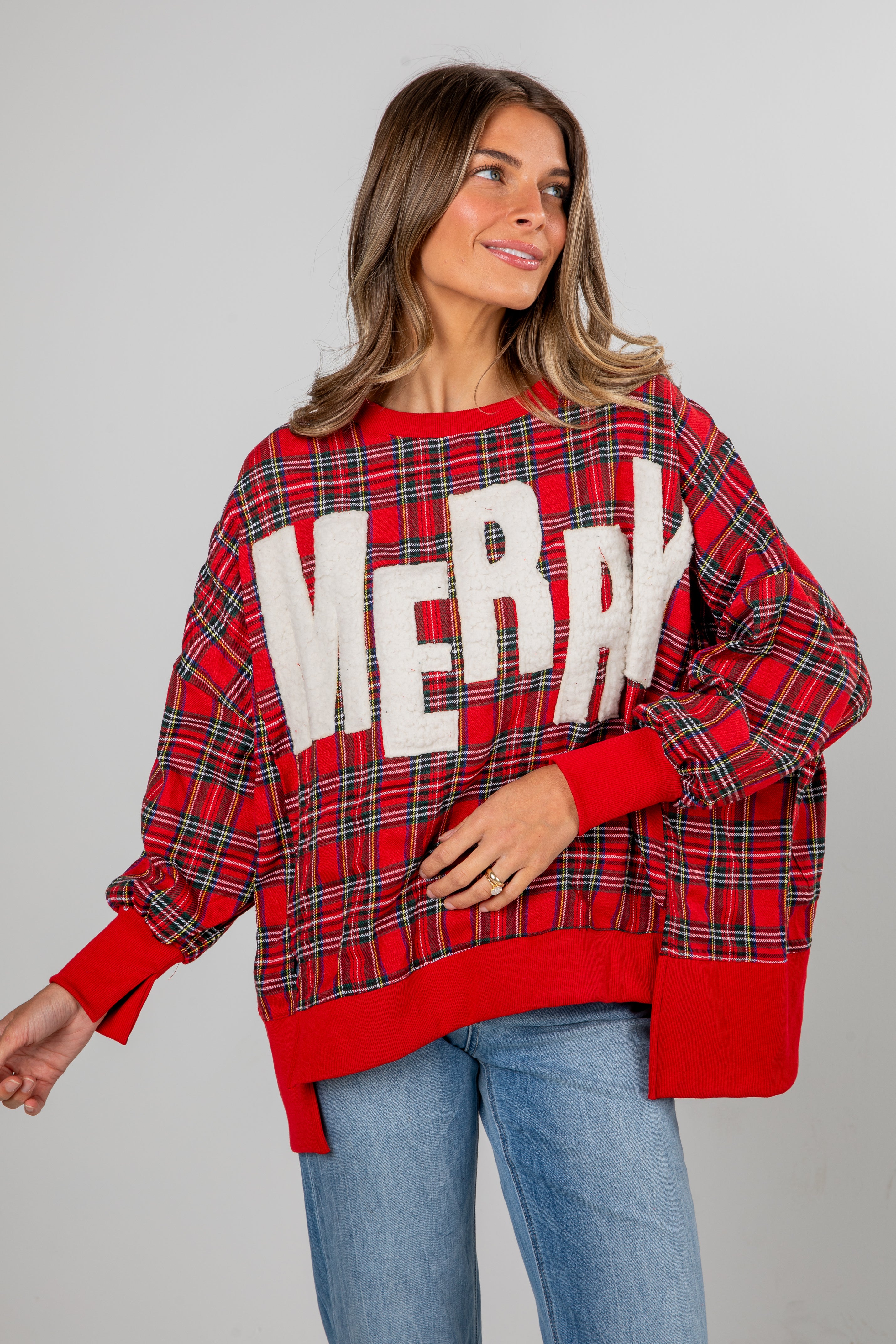 Woman wearing a red plaid sweater with &