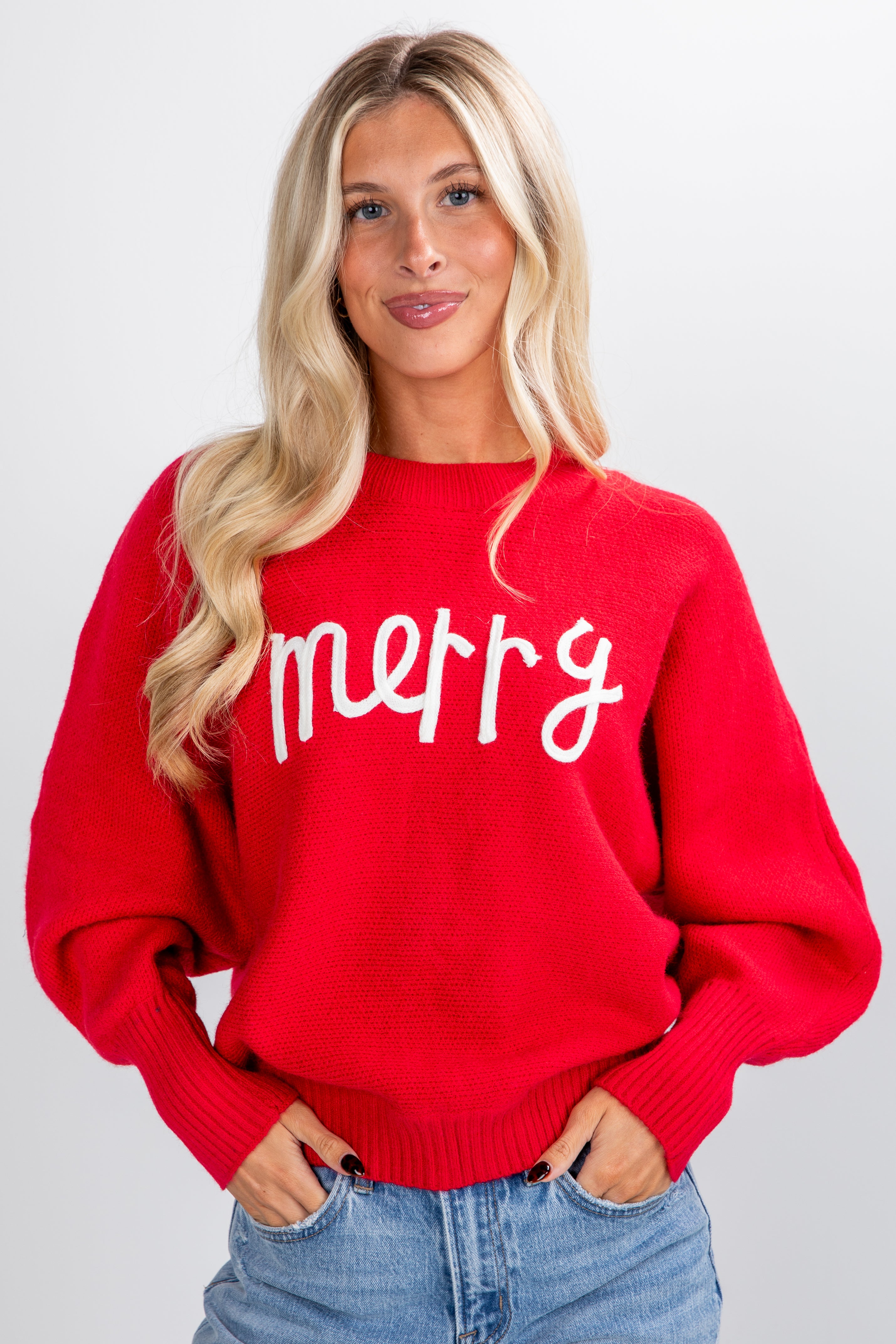 Woman wearing a red sweater with &