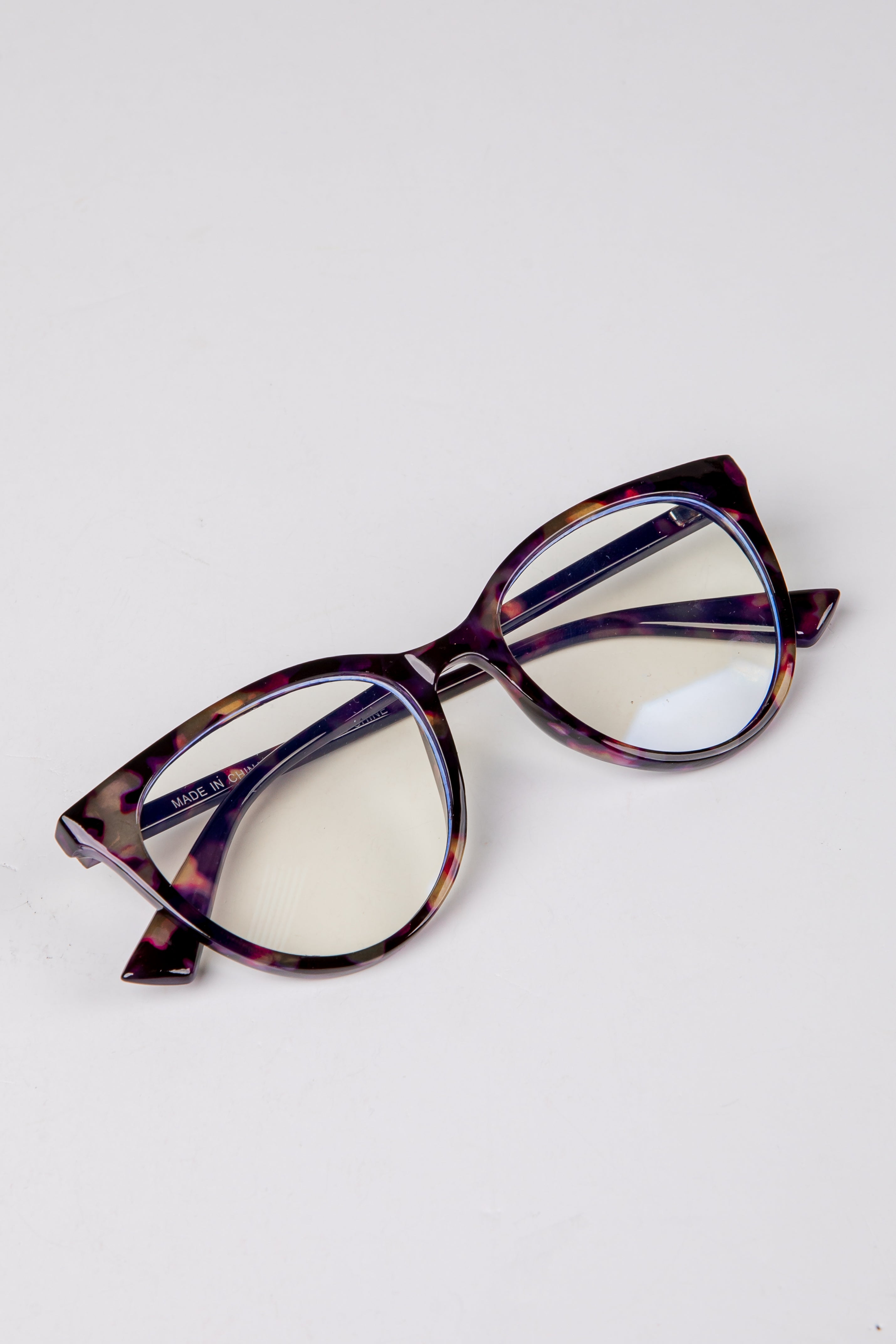 Cat-eye glasses with a tortoiseshell frame on a white background