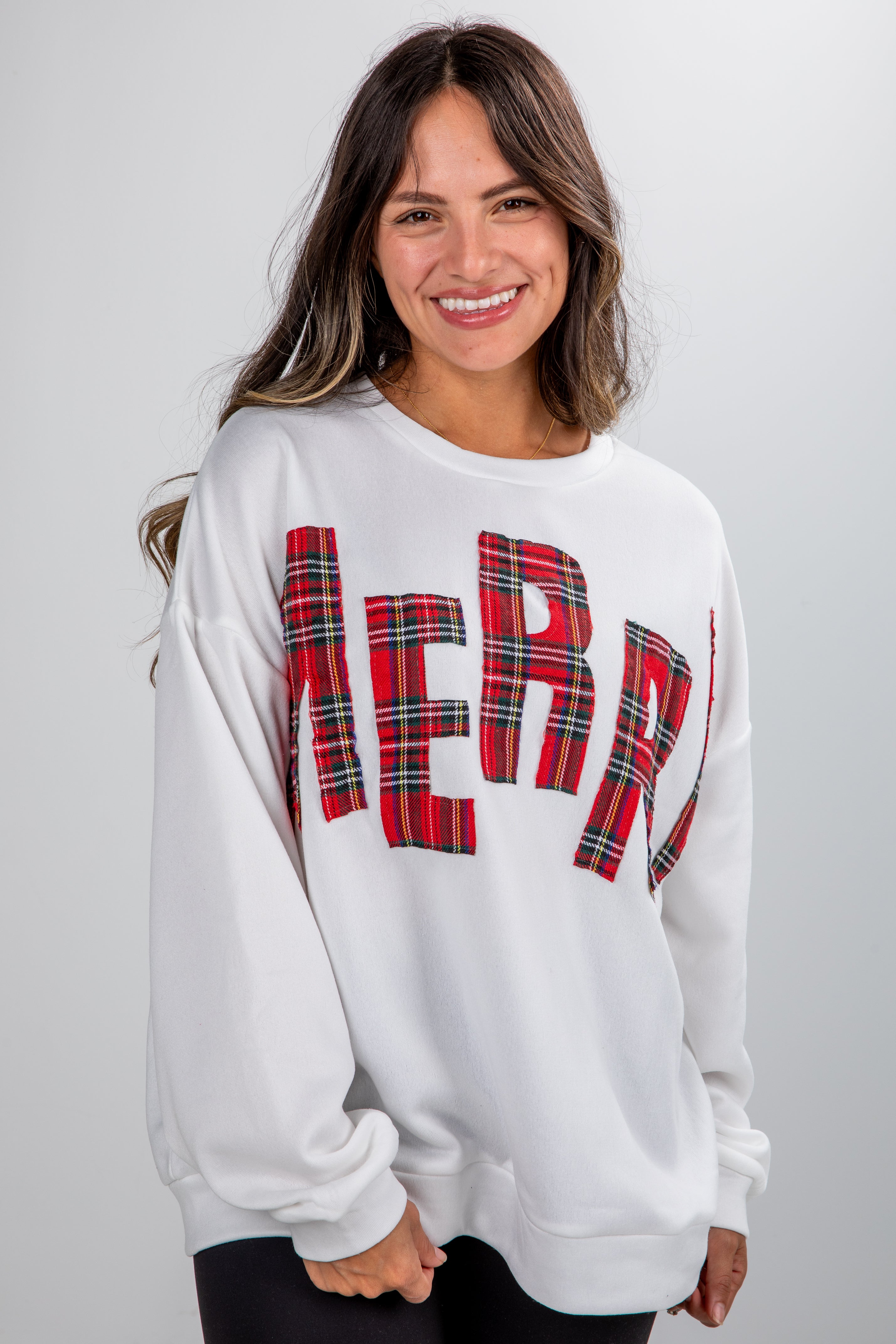 Woman wearing a white sweatshirt with &