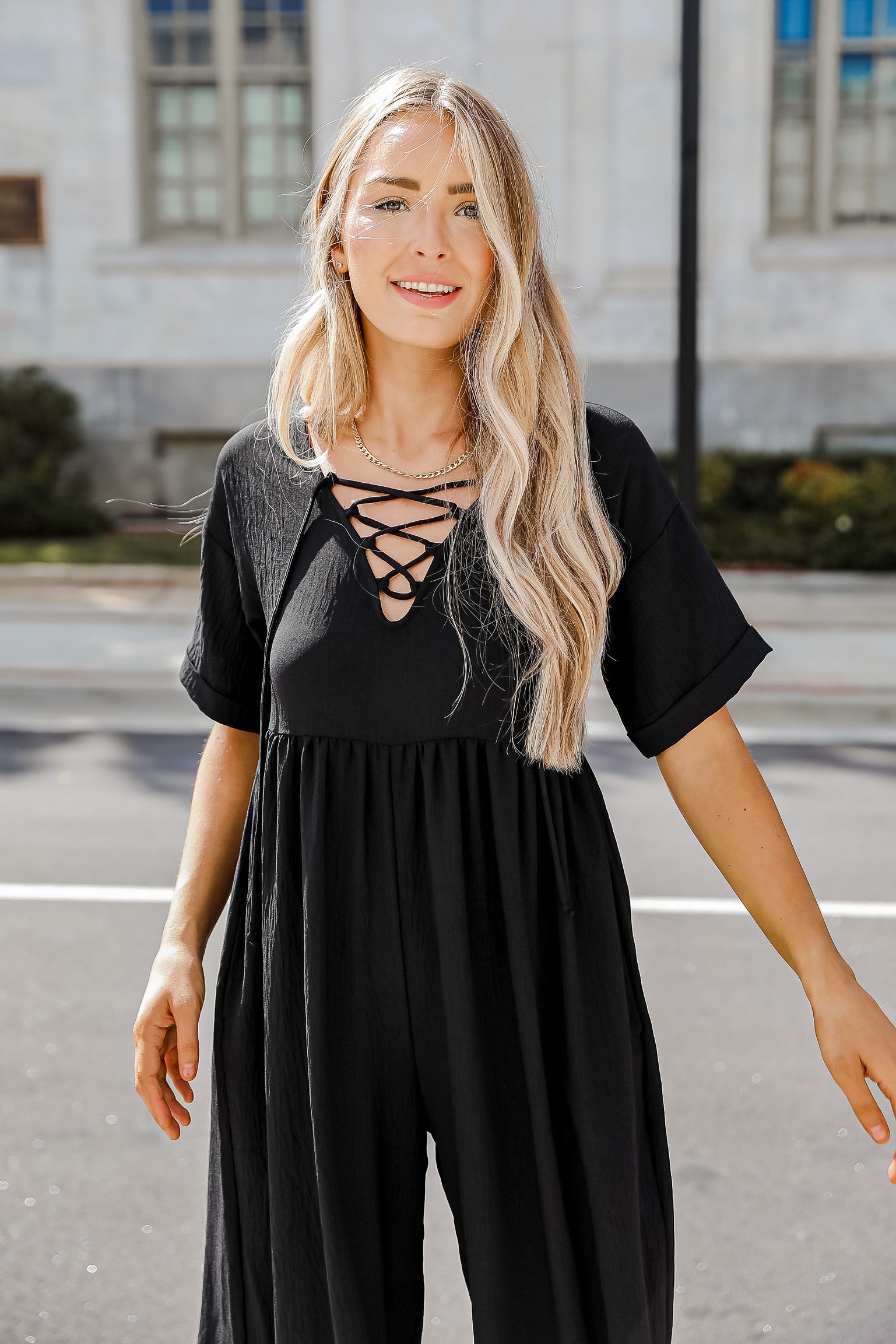 black jumpsuit on model with front laces