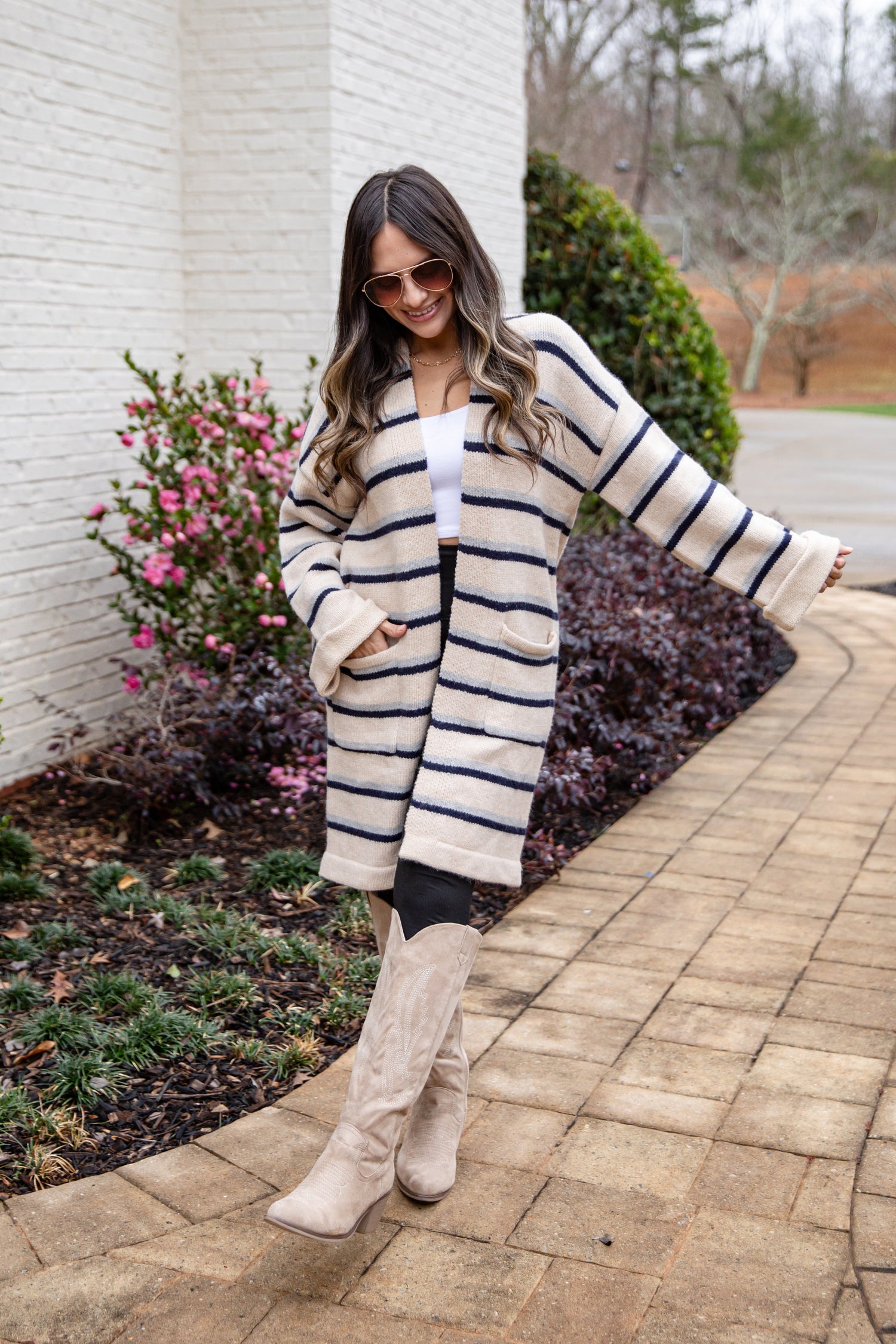 Woman wearing a cardigan and tan boots