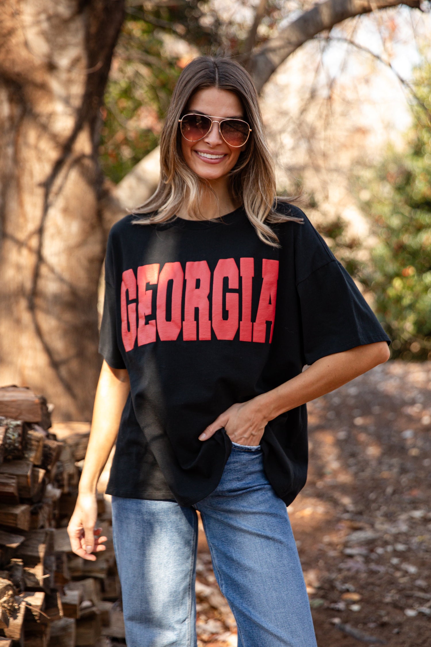 Model wearing a corded Georgia black pullover with red shorts. Cute outfit for gamedays