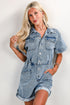 Woman wearing a denim dress against a plain background